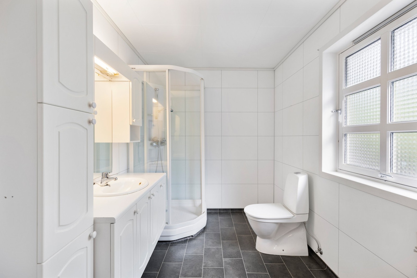 Badet i leiligheten ble oppusset i 2010 har har belegg på gulv og våtromsplater på vegger. Galleribilde