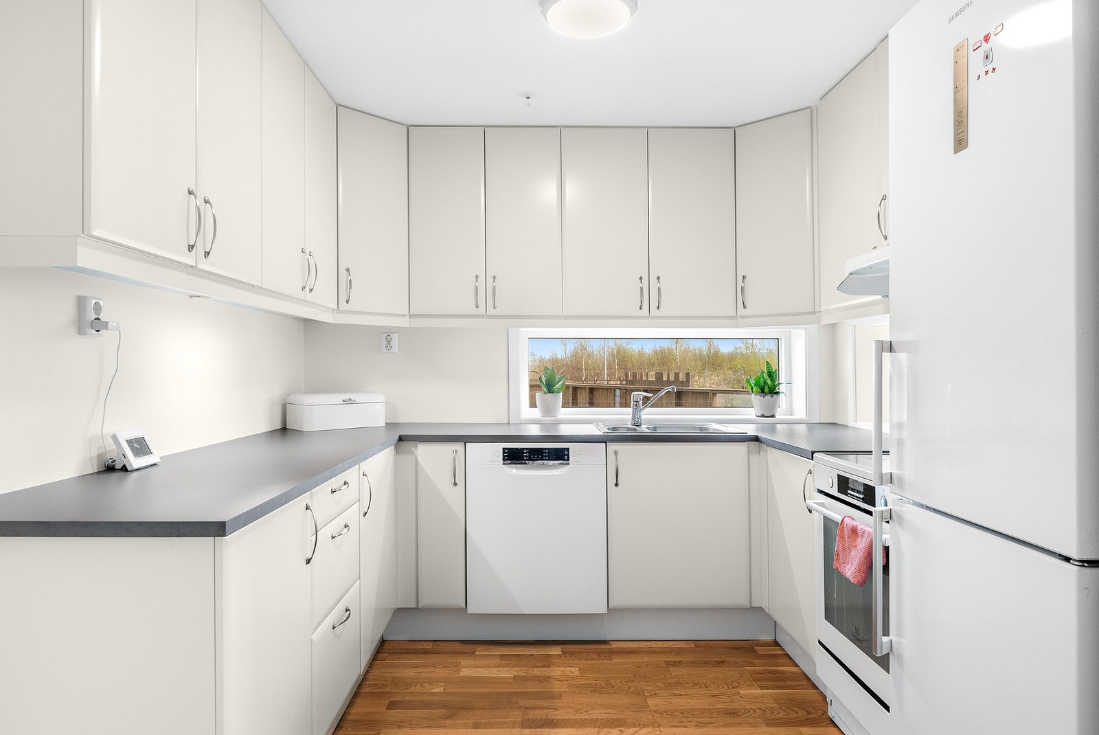 Kjøkkenet har fronter i hvit slett utførelse, godt utbygd med god oppbevaringsplass og rikelig med arbeidsflate. Galleribilde