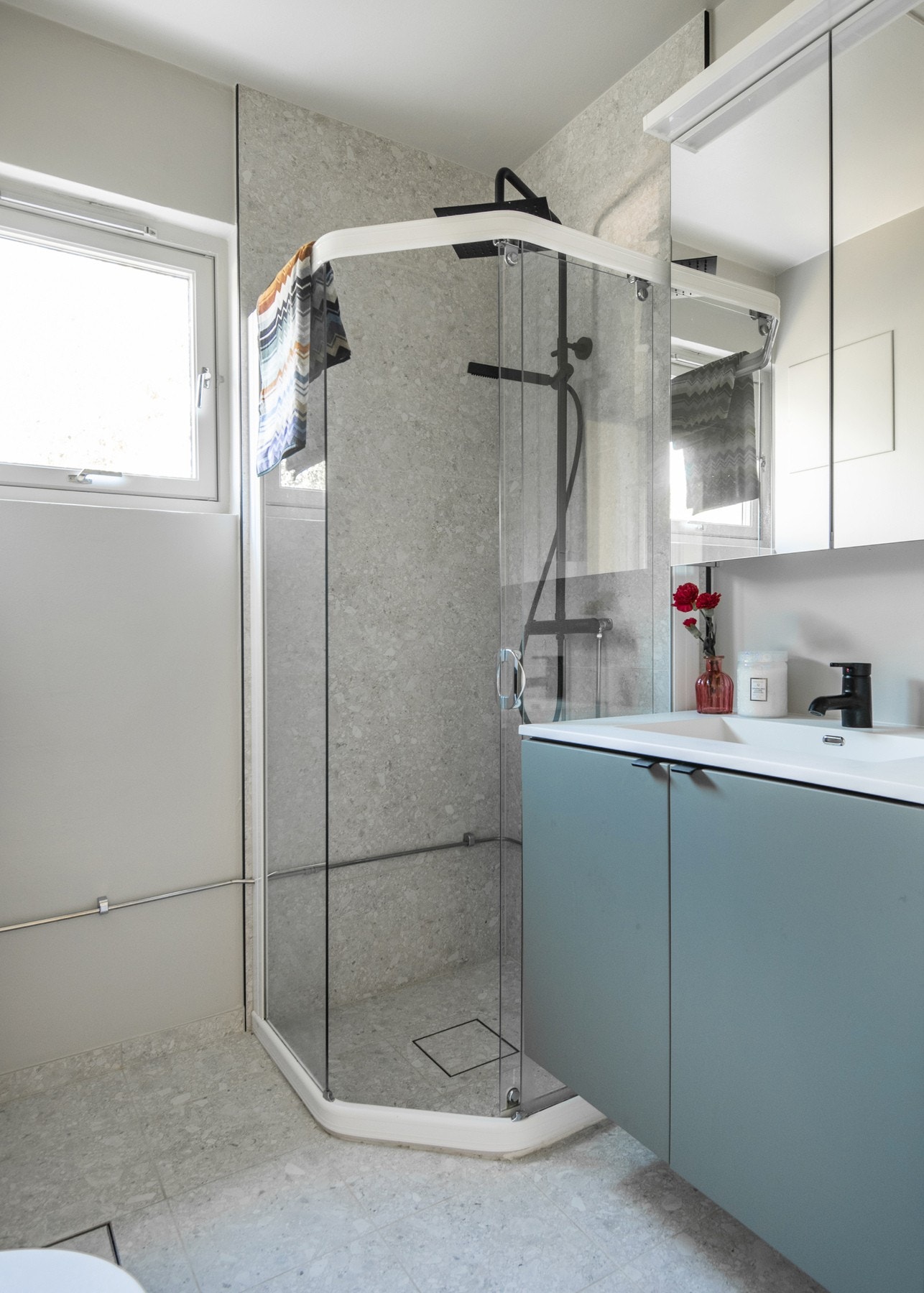 Badet er utstyrt med en lukket dusjnisje med skyvbare dusjvegger, servant med underskap, gulvmontert toalett og opplegg for vaskemaskin. Galleribilde