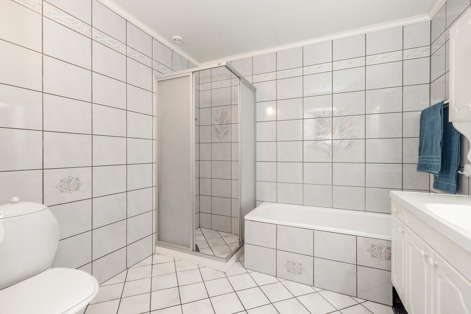 Badet er også innredet med dusjhjørne, badekar m/dusj og toalett. Galleribilde