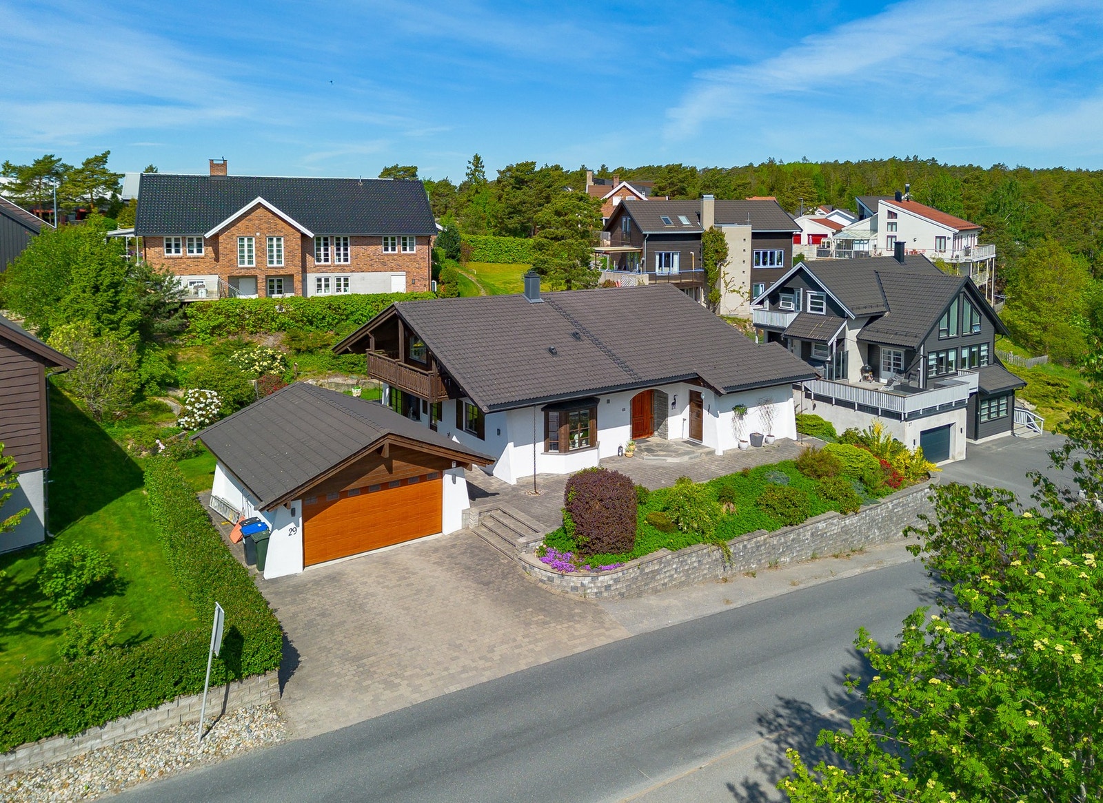 Et ekte Tyrolerhus med gode & gjennomførte detaljer. Stenkast gårdsplass. Forstøtningsmur mot vei. Dobbel garasje og granitt kantsten. Galleribilde