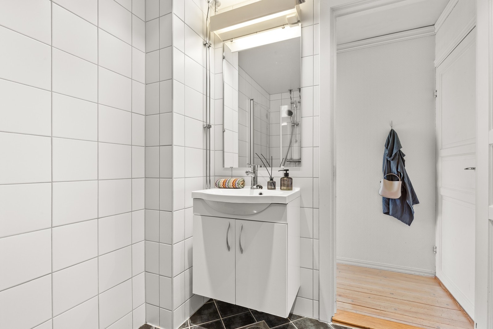 Det er felles varmtvann inkludert i felleskostnadene.
Pent flislagt bad med varmekabler på gulv.
Innredning med glatte fronter, heldekkende servant med overskap, speil og belysning. Galleribilde