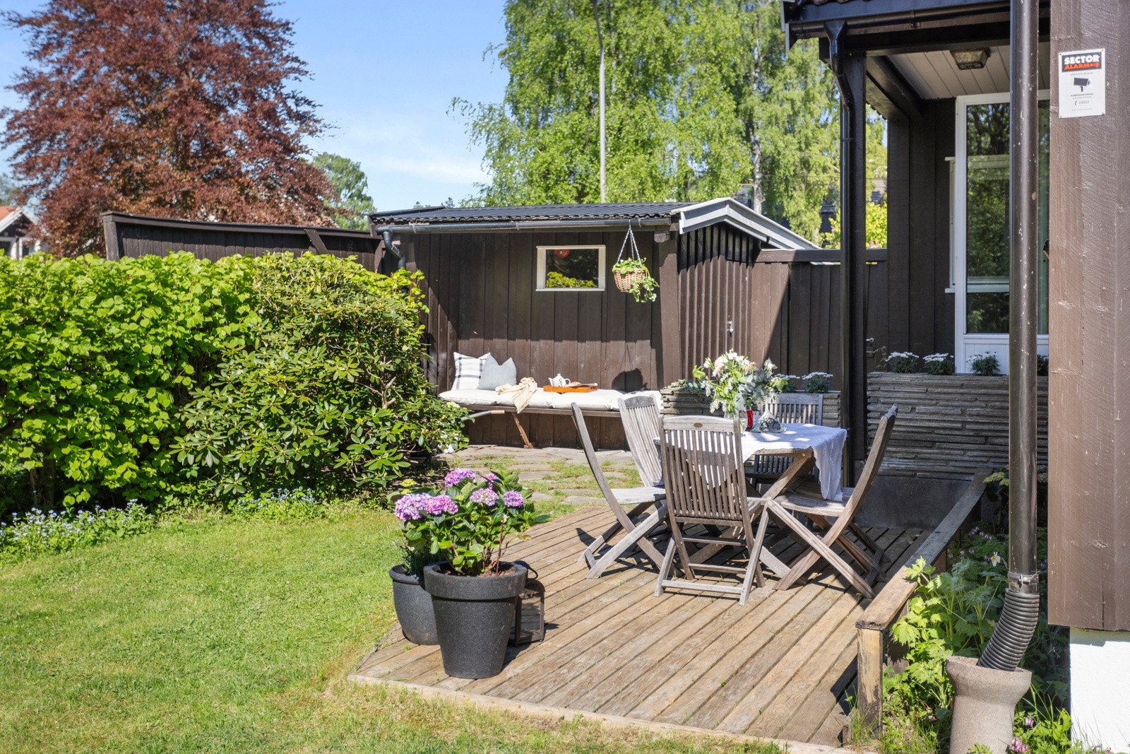 I flukt med hagen er det en lun markterrasse på ca. 10 kvm i tre Galleribilde