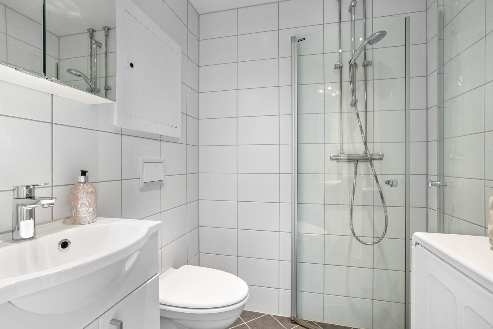 Lyst og pent, flislagt baderom med varme i gulv og downlightsbelysning i taket. Badet ble pusset opp i regi av borettslaget i 2017. Galleribilde