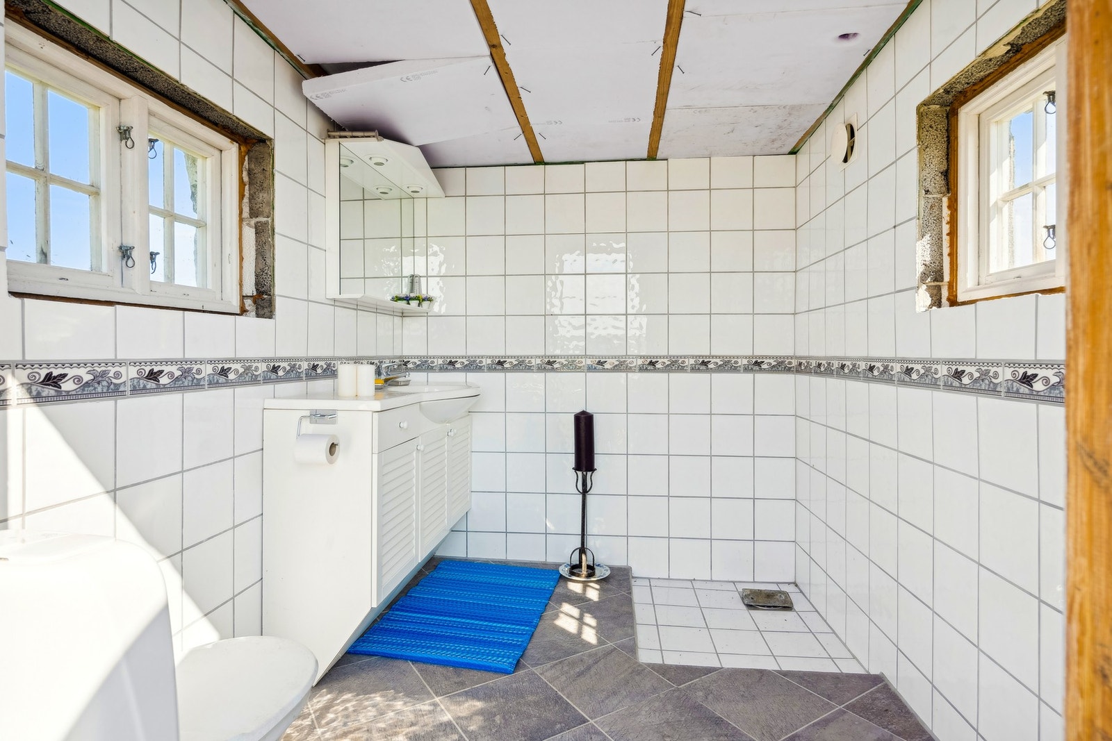 Innvendig i uthuset er det montert en vask og det er sluk i gulvet. Flislagte gulv og vegger. Vifte i vegg som er solcelledrevet. Galleribilde