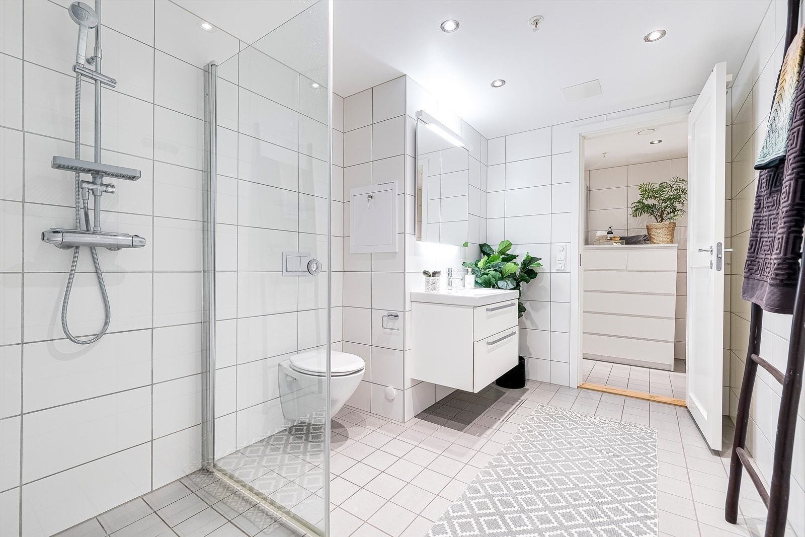 Det flislagte badet er lyst og romslig. Varmekablene i gulvet holder føttene varme når gradestokken kryper nedover. Fra badet har du adkomst til eget vaskerom. Galleribilde