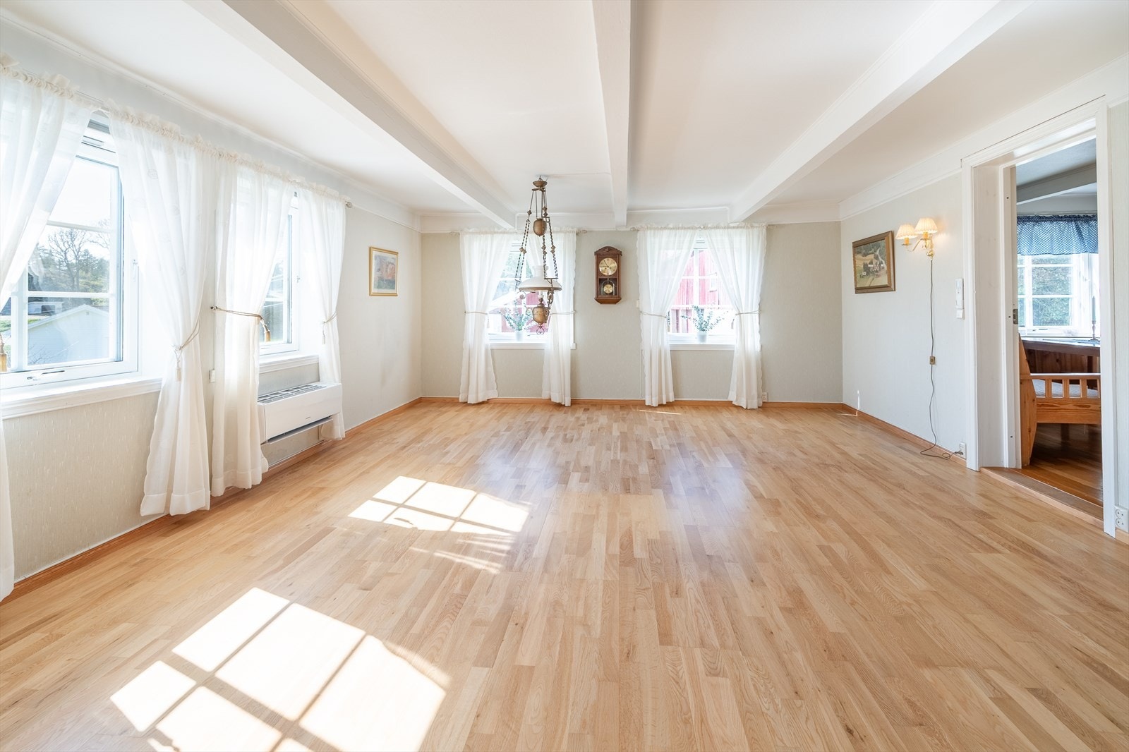 Stor og lys stue med store vindusflater Galleribilde