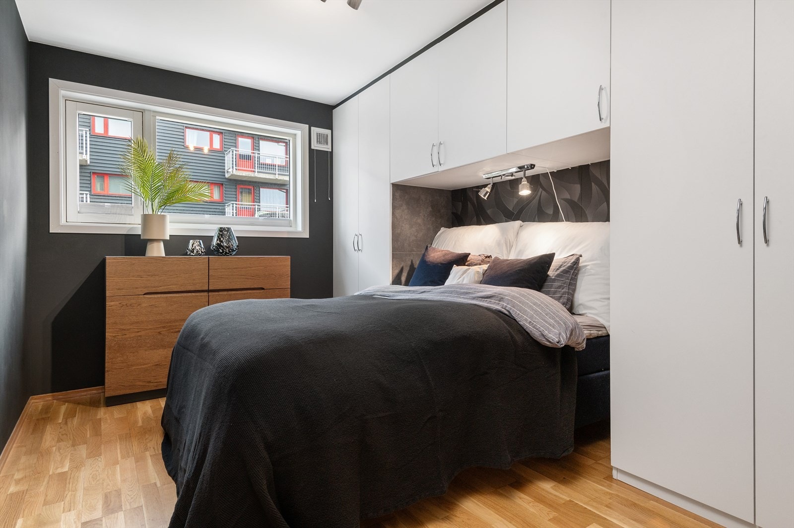 Leiligheten har et romslig soverom på 10,5 m² med oppmalte vegger i en avslappende mørk tone. Rommet har god plass til dobbeltseng, nattbord og kommode for oppbevaring. Galleribilde