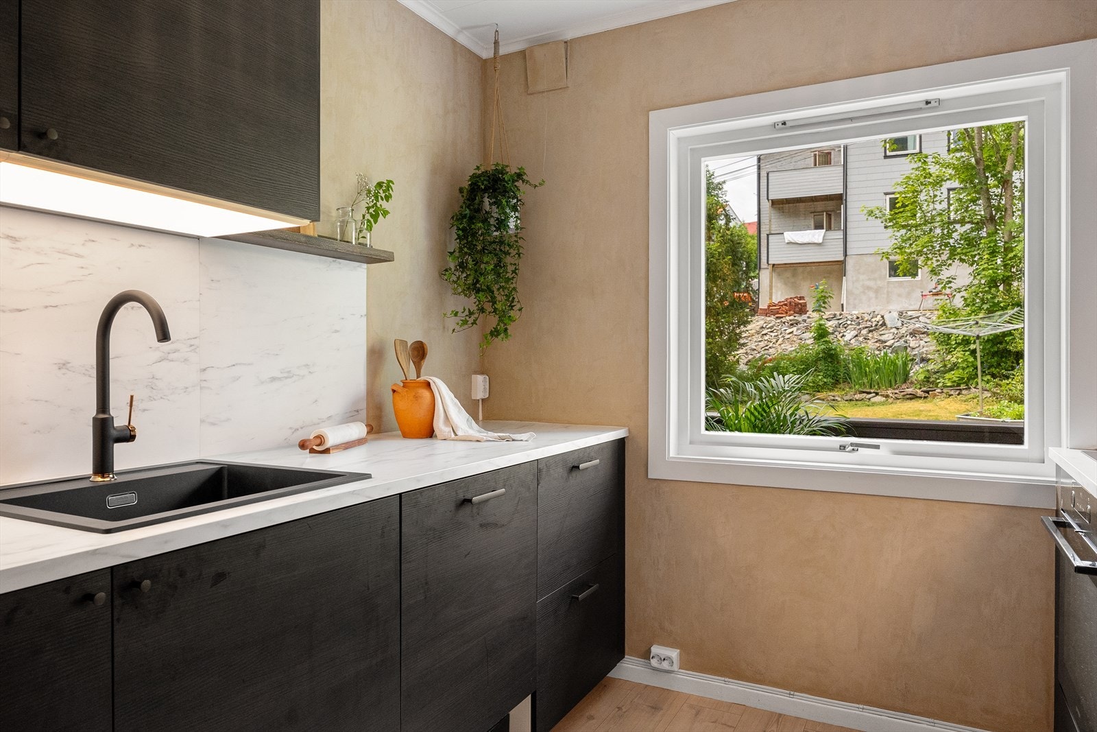 Innredningen består av sorte, slette fronter og laminat benkeplate med kompositt vaskebeslag. Galleribilde