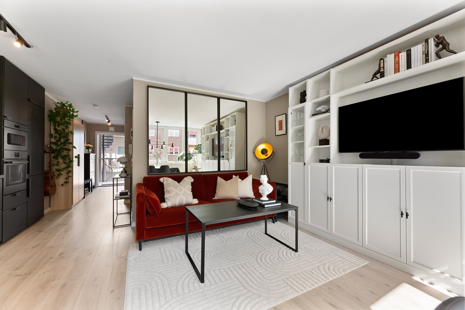 Den store stuen har mange innredningsmuligheter og plass til flere soner. TV-en henger på en spesialbestilt arm som medfølger kjøpet. TV-en kan derfor enkelt trekkes ut fra veggen. Galleribilde