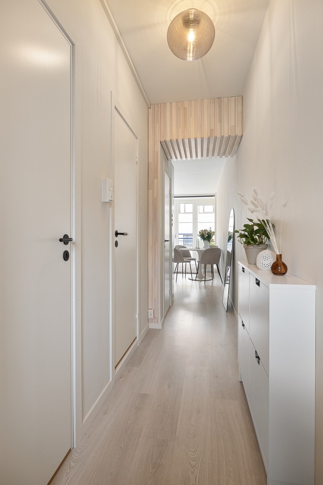 Bod/garderobe, bad og soverom henger sammen i en lys gang med lekre spiler som bryter opp de glatte flatene. Galleribilde