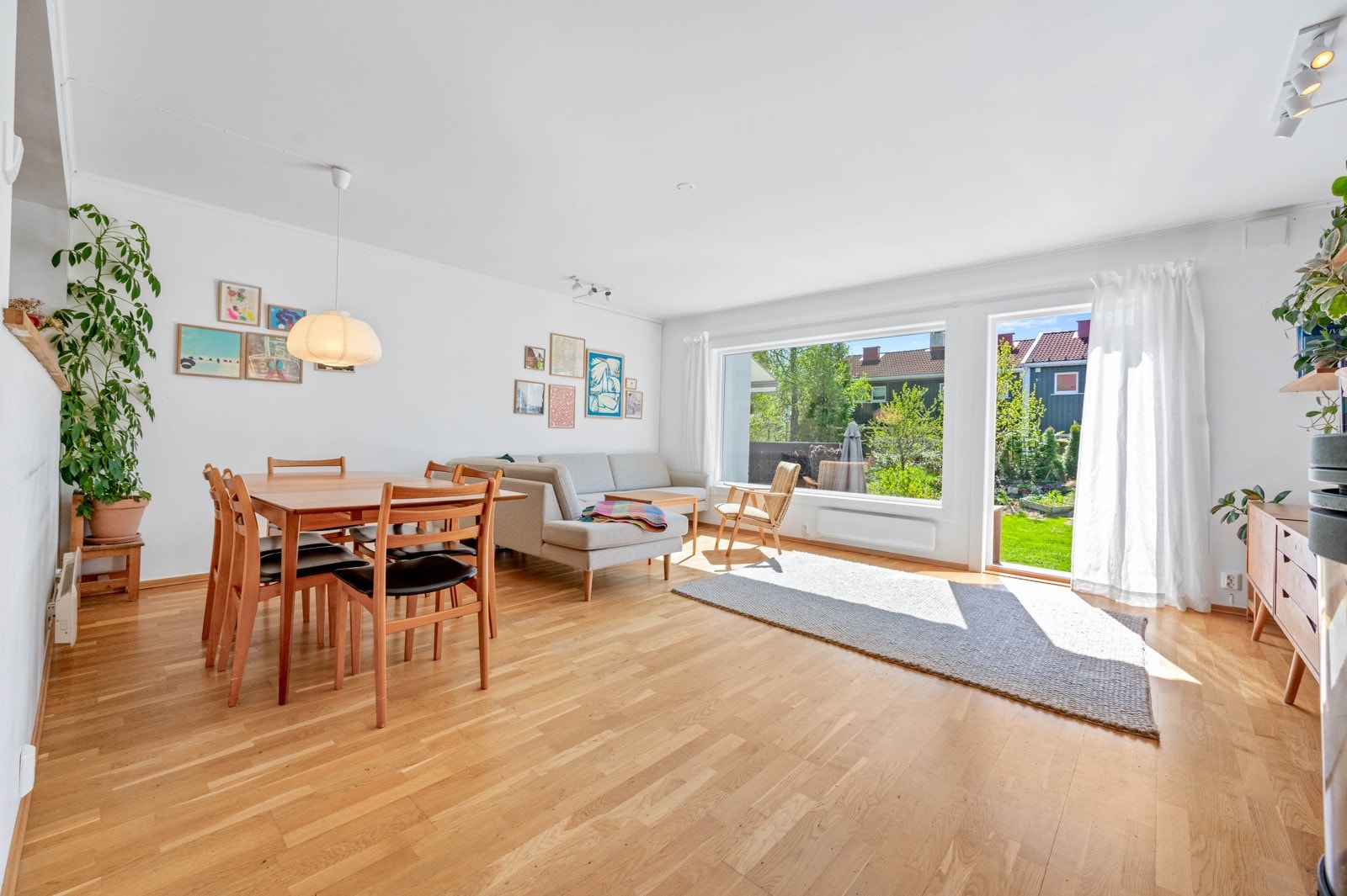 Et luftig oppholdsrom med plass til salong og spisegruppe. Direkte utgang til en stor terrasseplatting og til den flotte hagen. Galleribilde