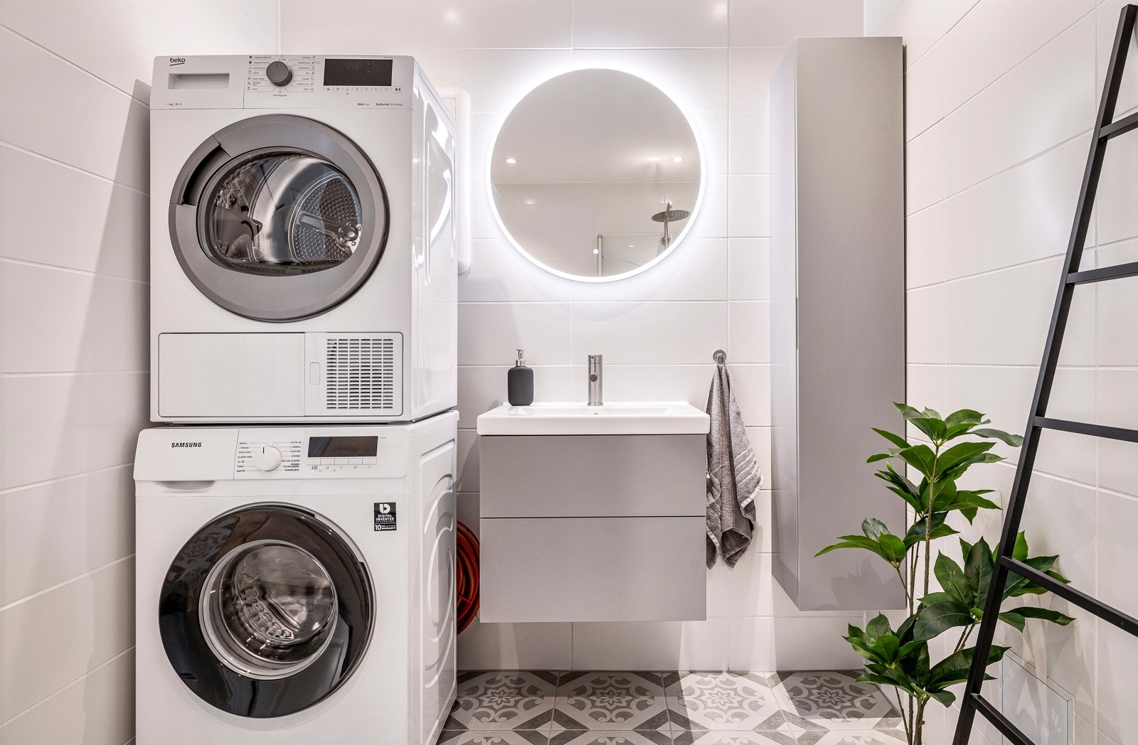 Badet er innredet med vegghengt toalett, dusj med glass foldedører, servant med møblement, speil og belysning Galleribilde