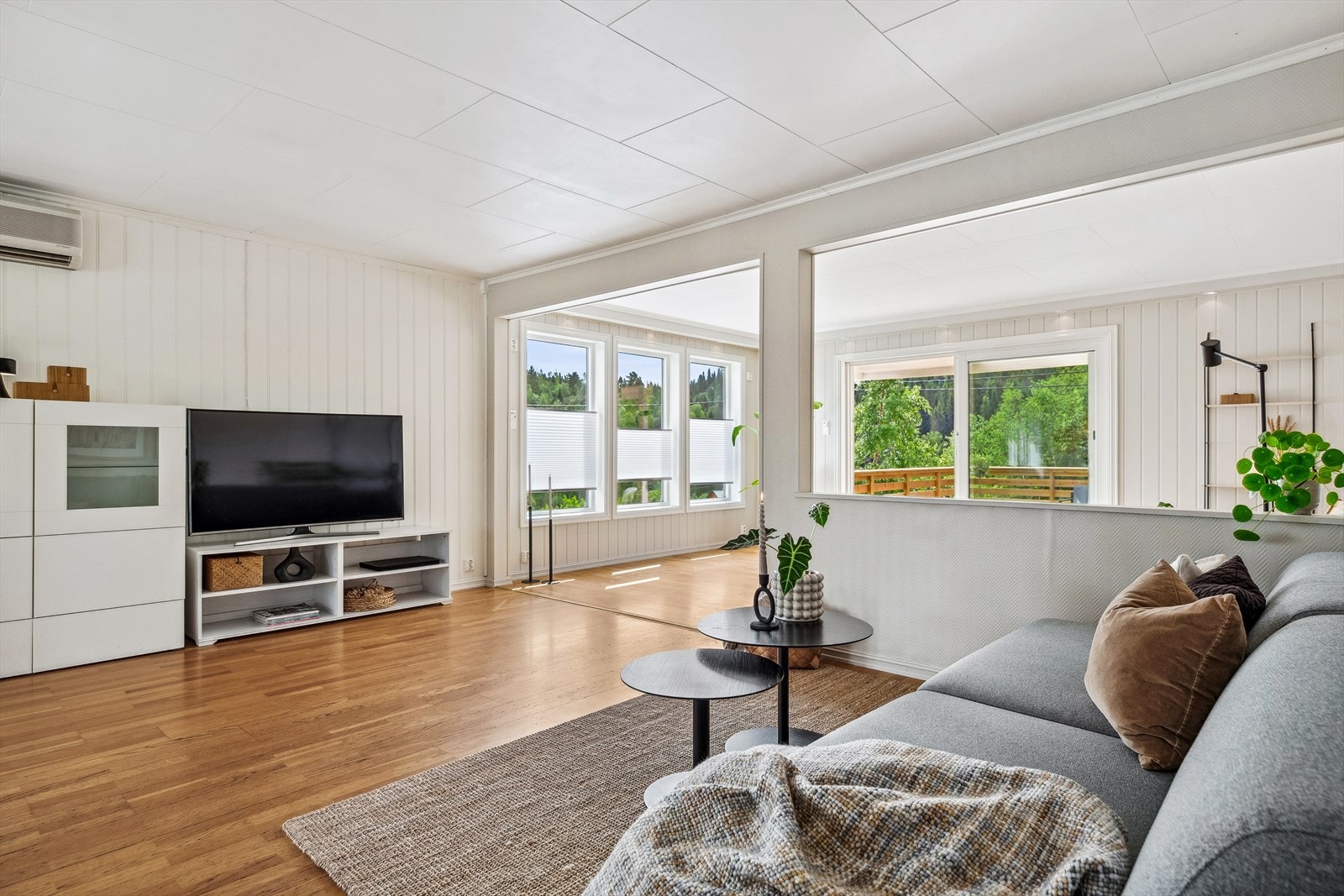 De lysmalte overflatene i stuen fremhever det gylne parkettgulvet. Galleribilde