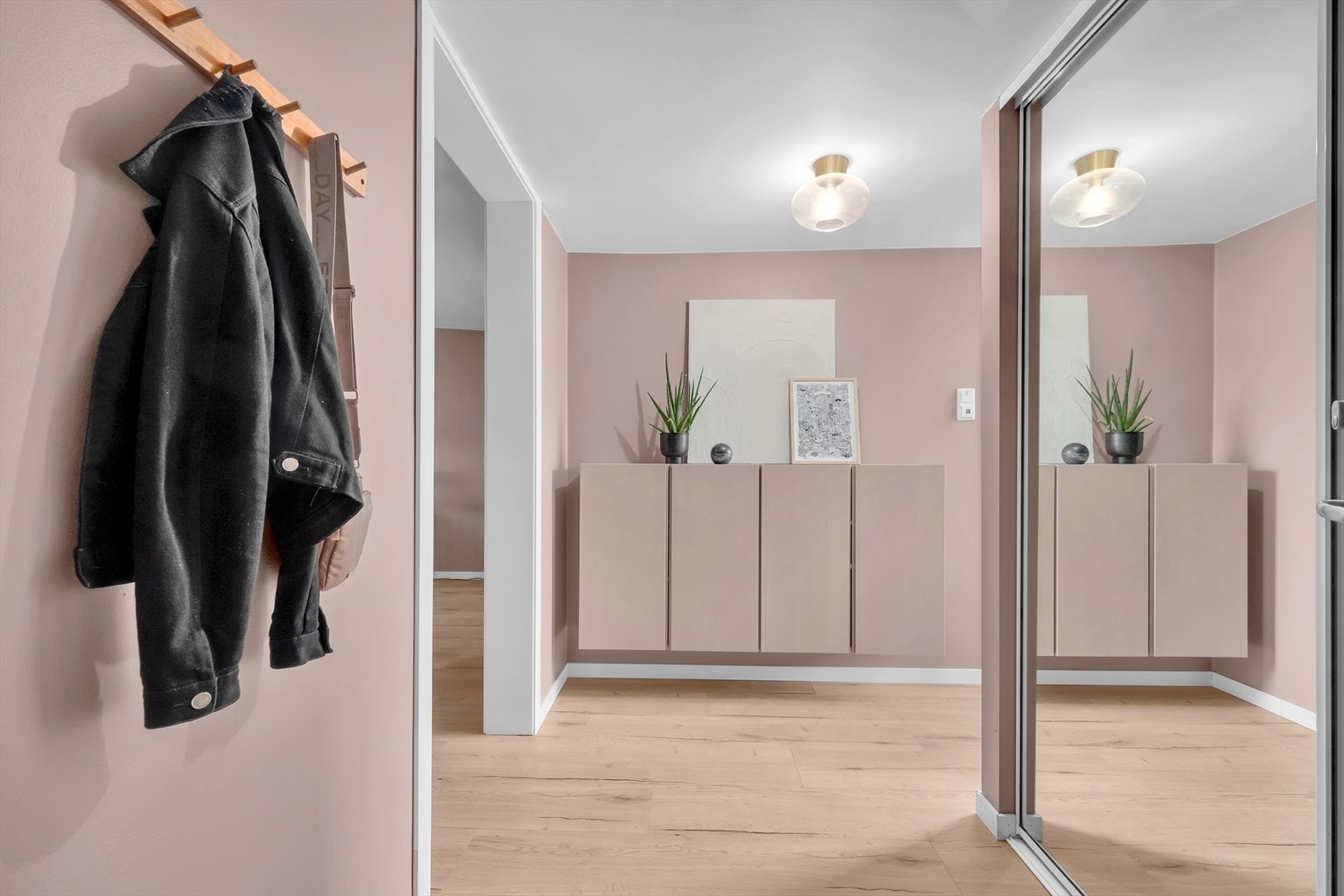 Velkommen inn! I entréen finner du en stort skyvedørsgarderobe med speil. Dette garderobeskapet strekker seg langs en av veggene og tilbyr rikelig med plass for oppbevaring Galleribilde