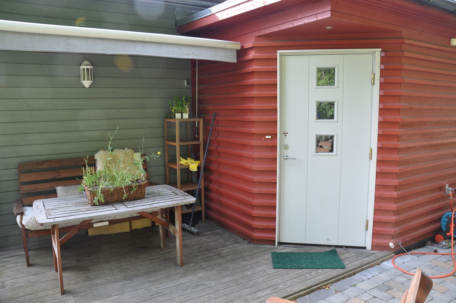 Inngangspartiet til leiligheten med egen terrasse og markise Galleribilde