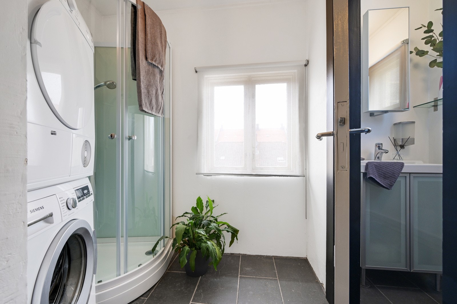 I gangen finner vi vaskerommet med WC. Flislagt gulv med varmekabler, dusjkabinett og opplegg for vaskemaskin Galleribilde