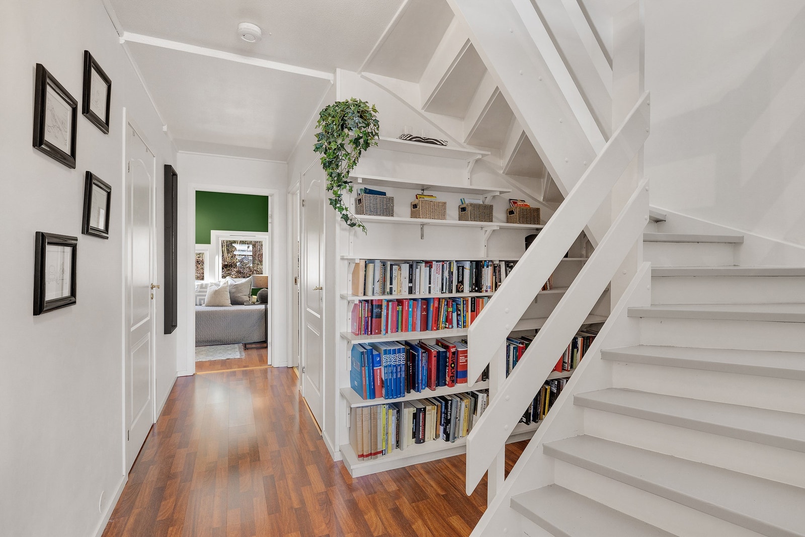 Stor trappegang mellom etasjene med hyllesystem. Galleribilde