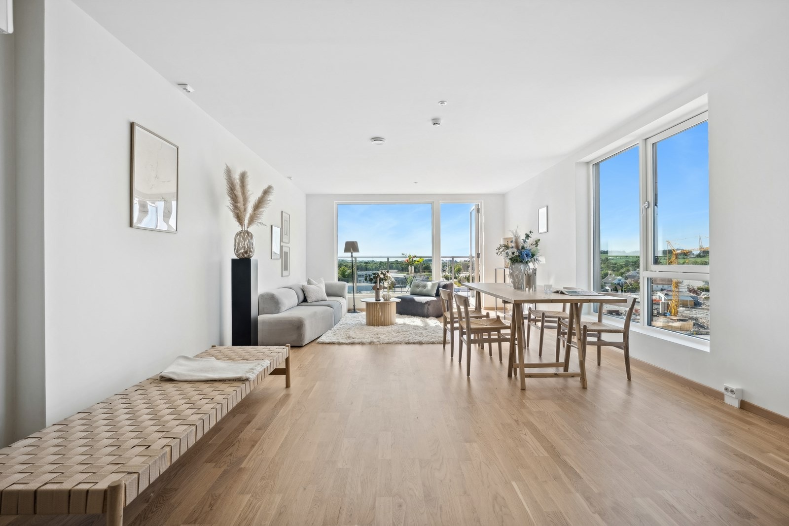 Store vindusflater fra flere sider sørger for rikelig med naturlig lys inn i boligen Galleribilde