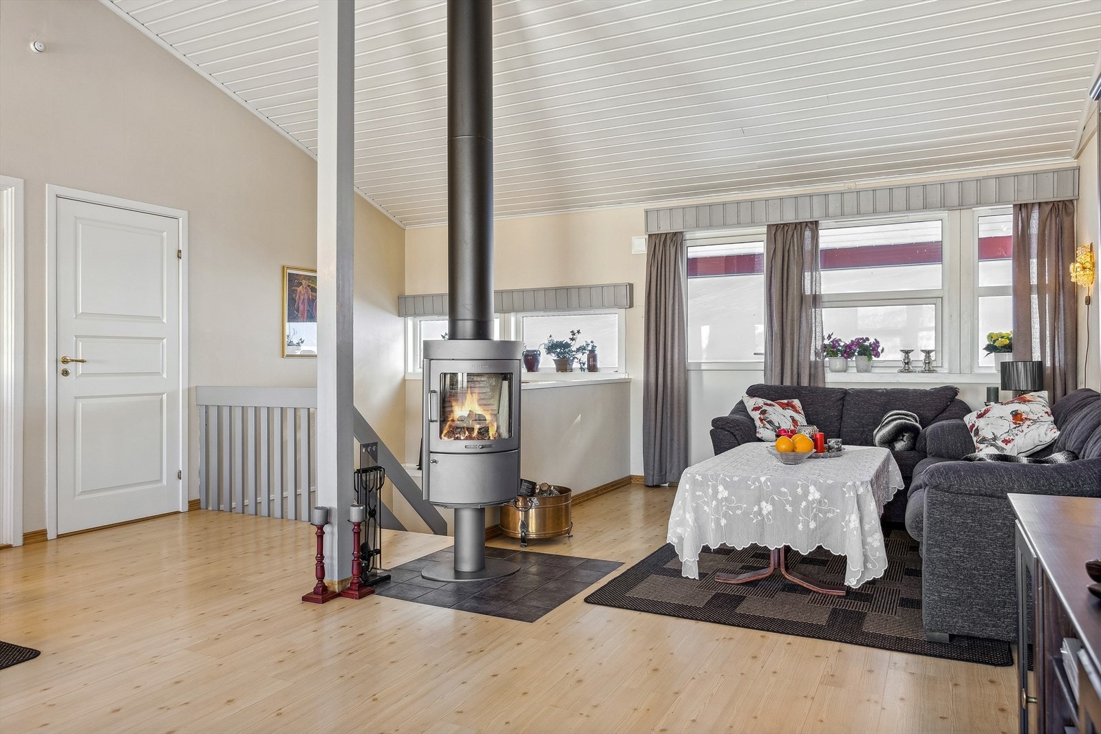 Lys og innbydende stue med moderne, frittstående peis og klassisk innredning. Galleribilde