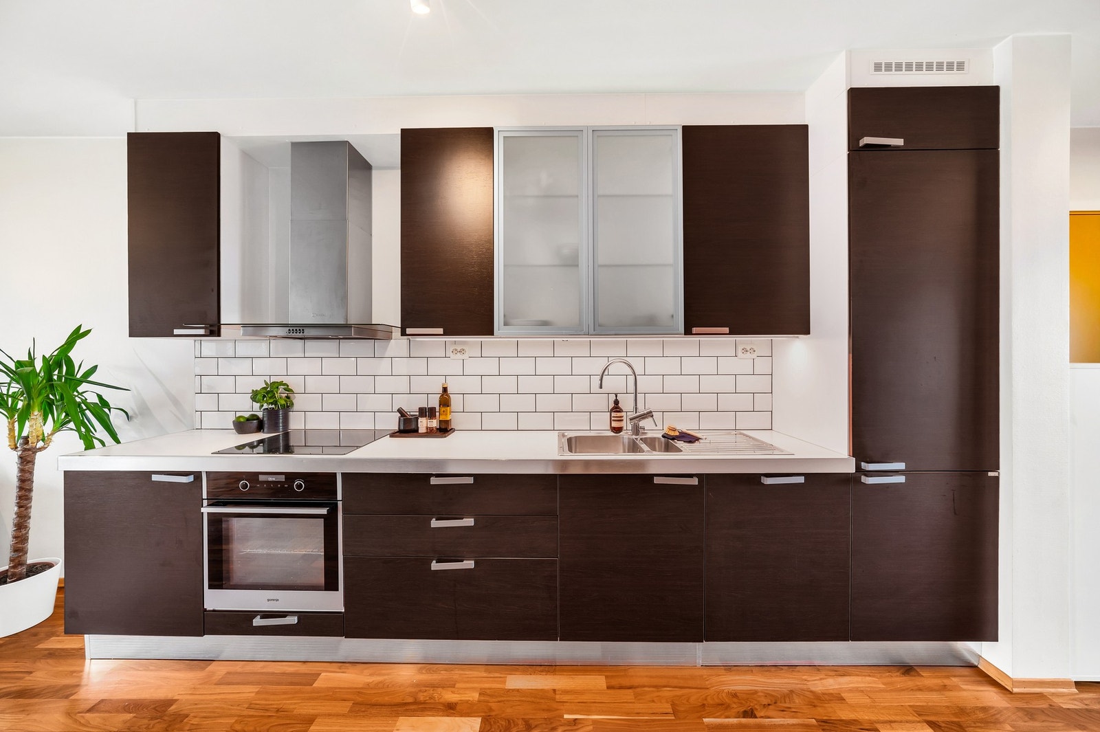 Tidløst kjøkken med integrert platetopp, stekeovn, oppvaskmaskin og kjøl/fryseskap. Galleribilde