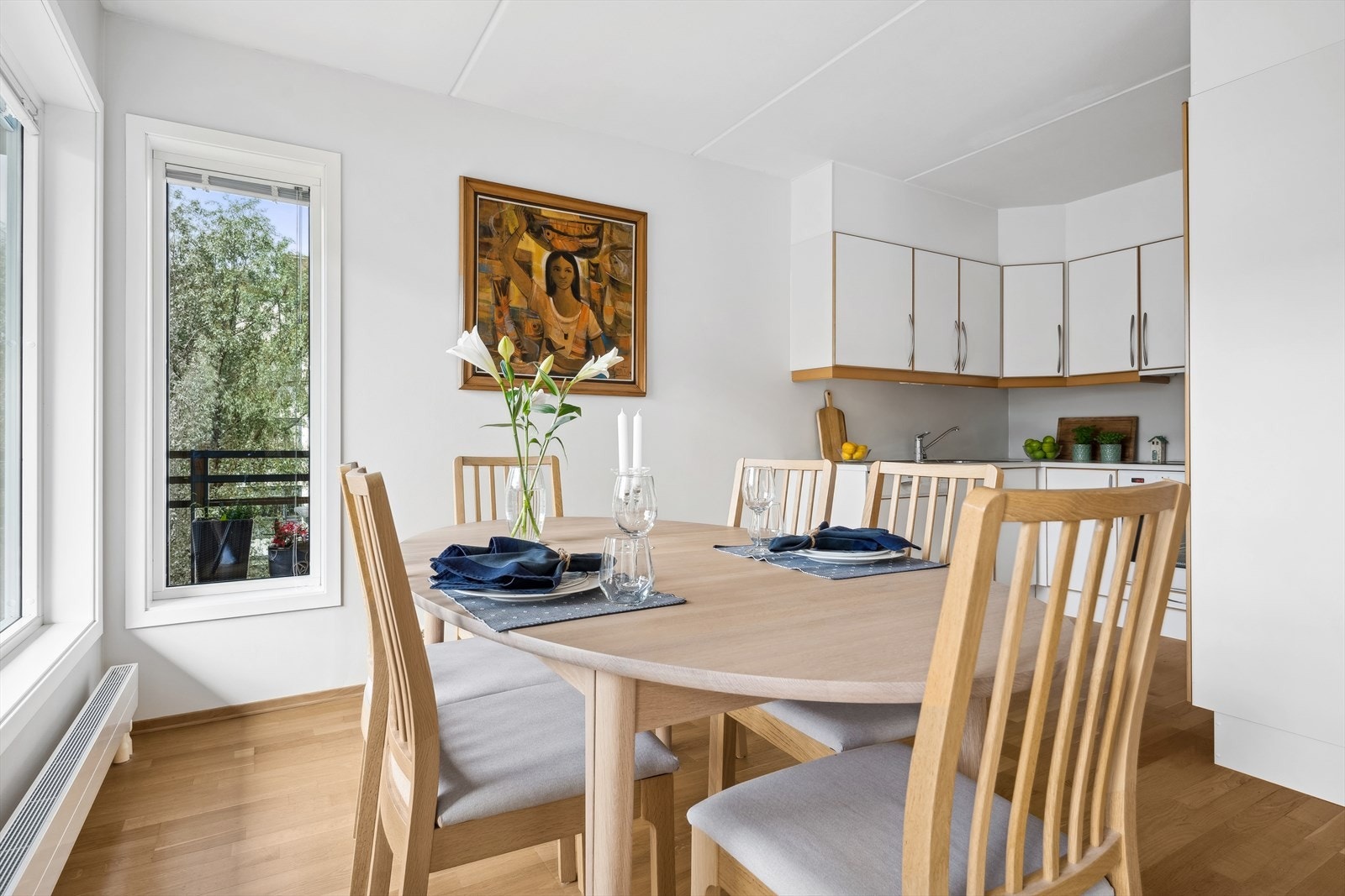 Et lyst kjøkken i delvis åpen løsning mot stuen. Galleribilde