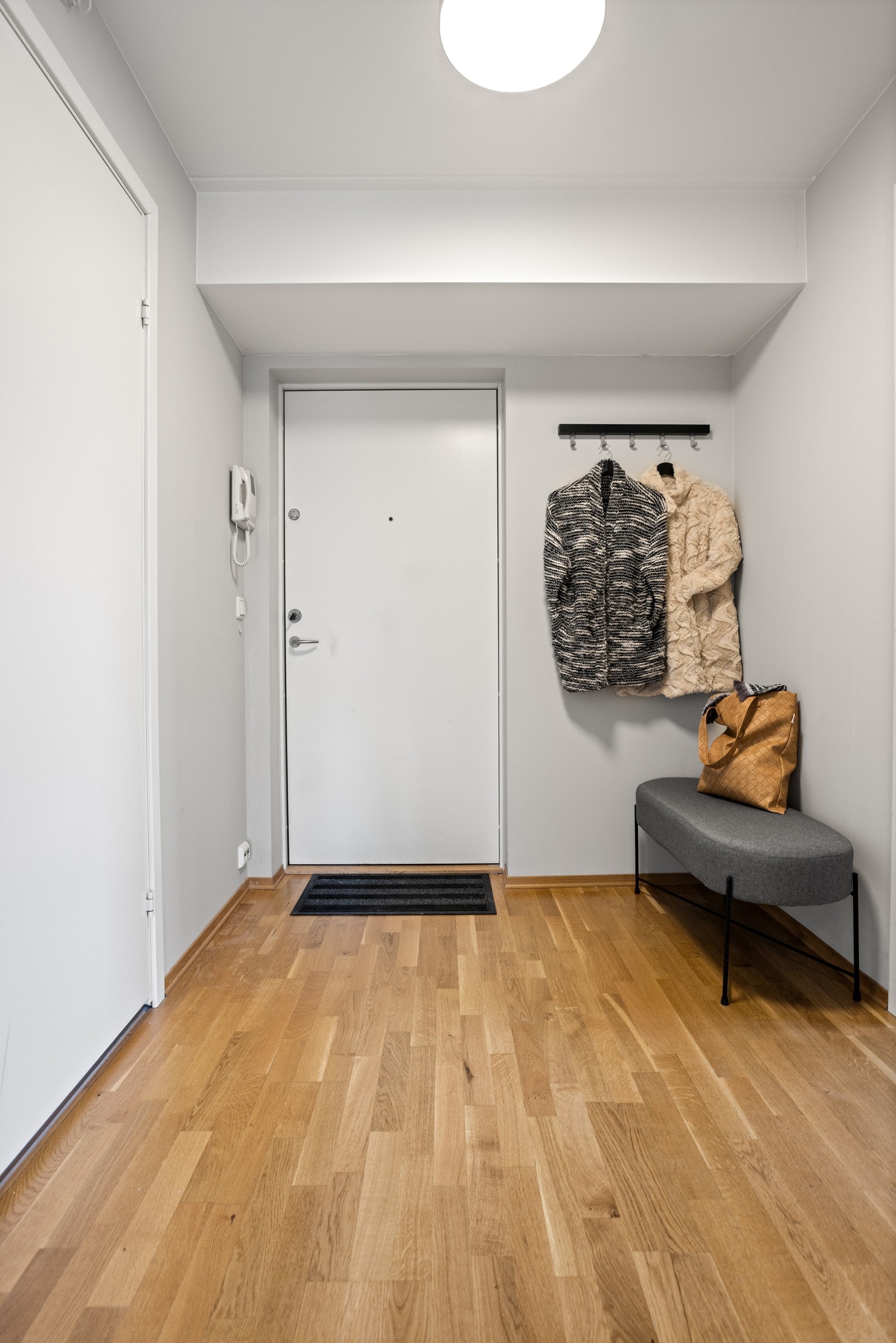 Vel inne ønskes man velkommen av en innbydende entré med parkettgulv og veggflater malt i en dus gråtone Galleribilde