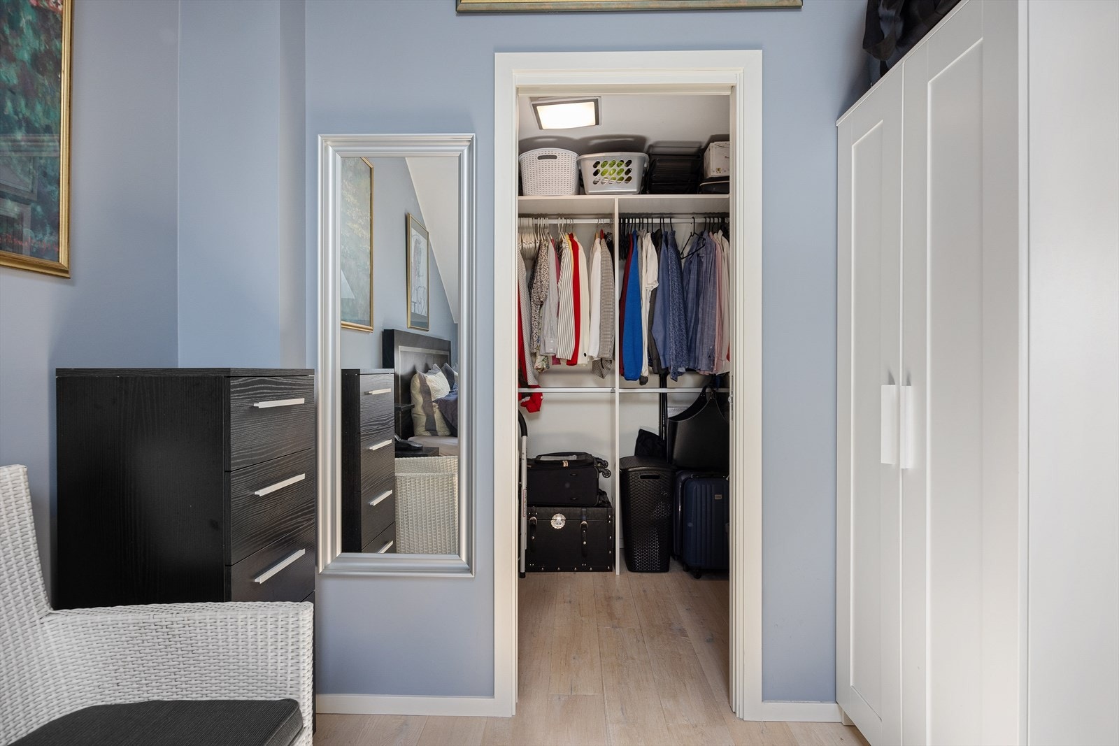 Fra soverommet er det tilgang til en praktsik walk-in-garderobe. Denne romslige garderoben er utstyrt med en åpen garderobeløsning, noe som gir enkel tilgang og oversikt over klær og tilbehør. Galleribilde
