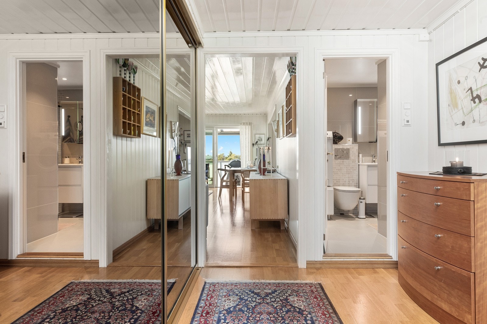 Vel innenfor dørene kommer man først inn i en svært romslig gang, med god plass til å henge fra seg yttertøy i plassbygget skyvedørsgarderobe. Galleribilde