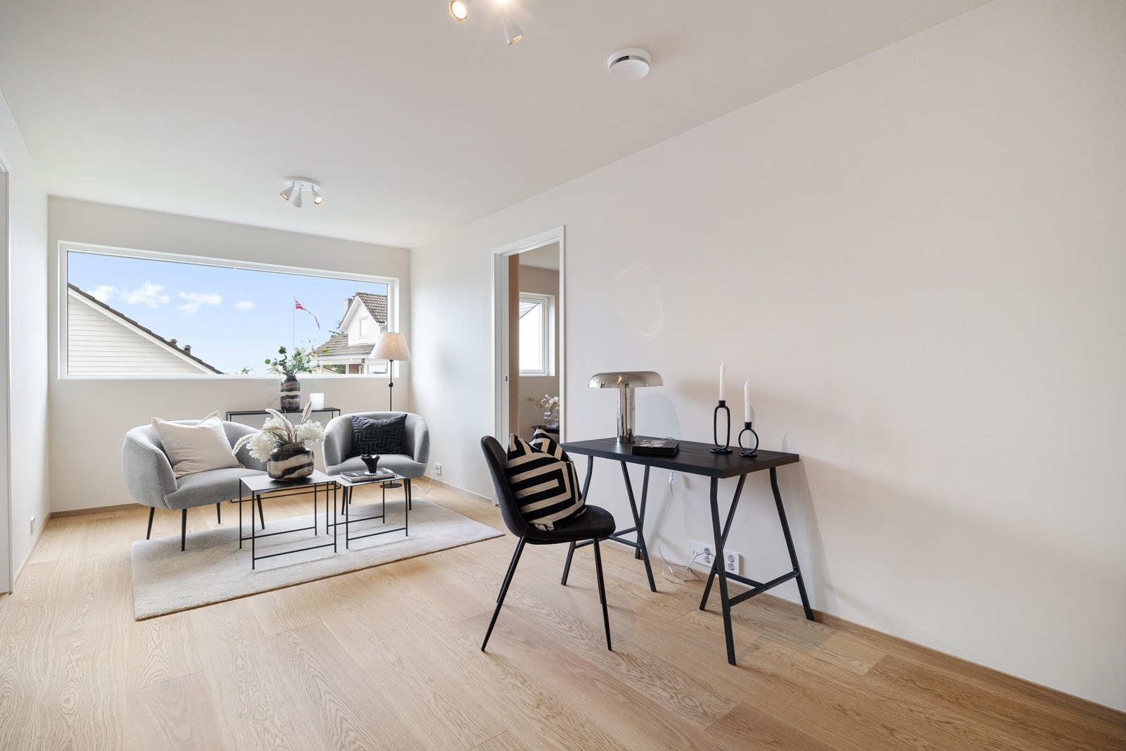 Det er slette, malte vegger og enstavs parkett, og på enden er det et langsgående vindu som bidrar til gode lysforhold. Galleribilde