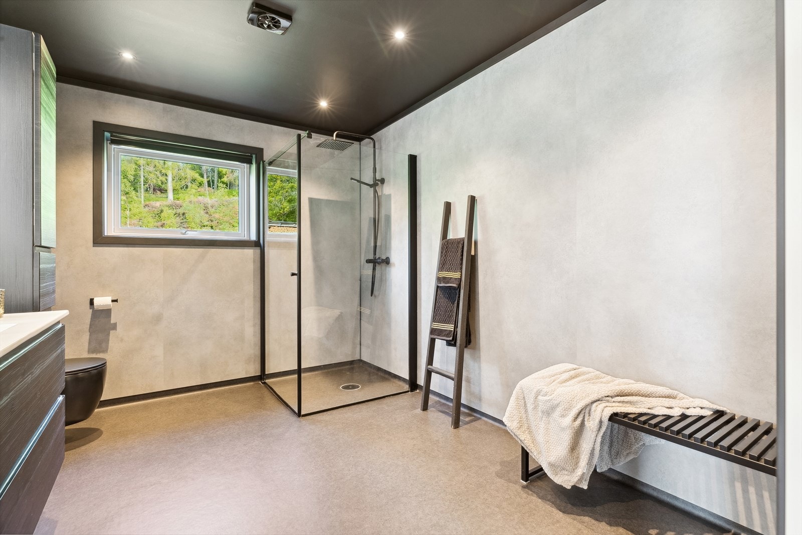 Badet ble oppgradert i 2021 og har en gjennomført, moderne stil med regndusj og sorte detaljer. Galleribilde