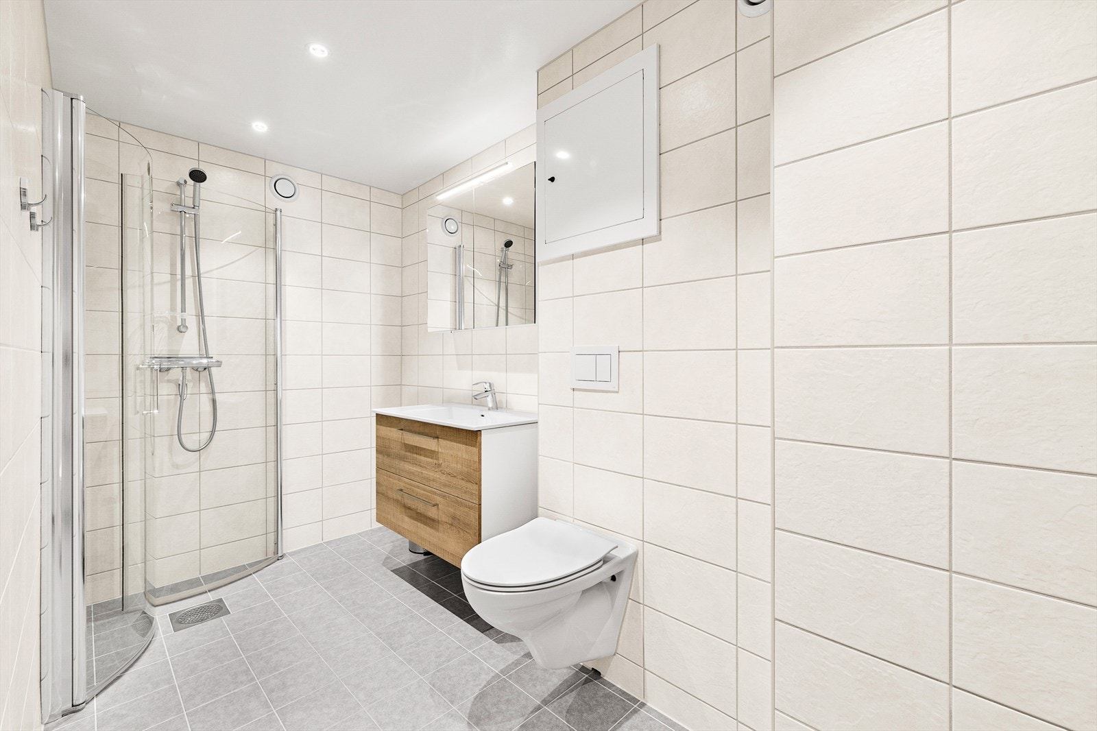 Det flislagte badet, oppgradert i 2021 i regi av borettslaget, tilbyr en moderne og elegant atmosfære med stilrene detaljer og høy kvalitet. Galleribilde