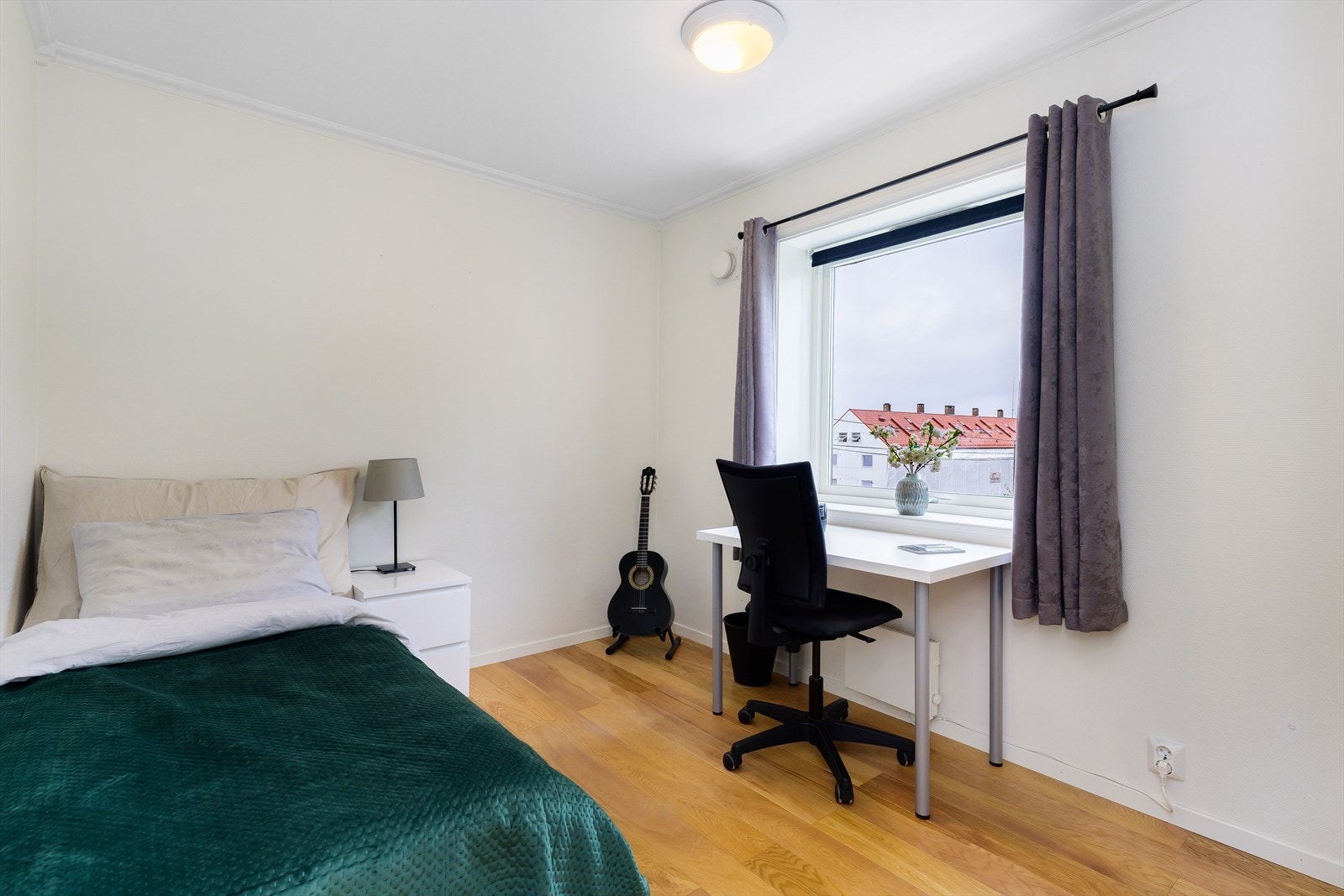 Lys og tiltalende soverom med praktisk arbeidskrok, ideell for studier eller hjemmekontor. Soverom 1. Galleribilde