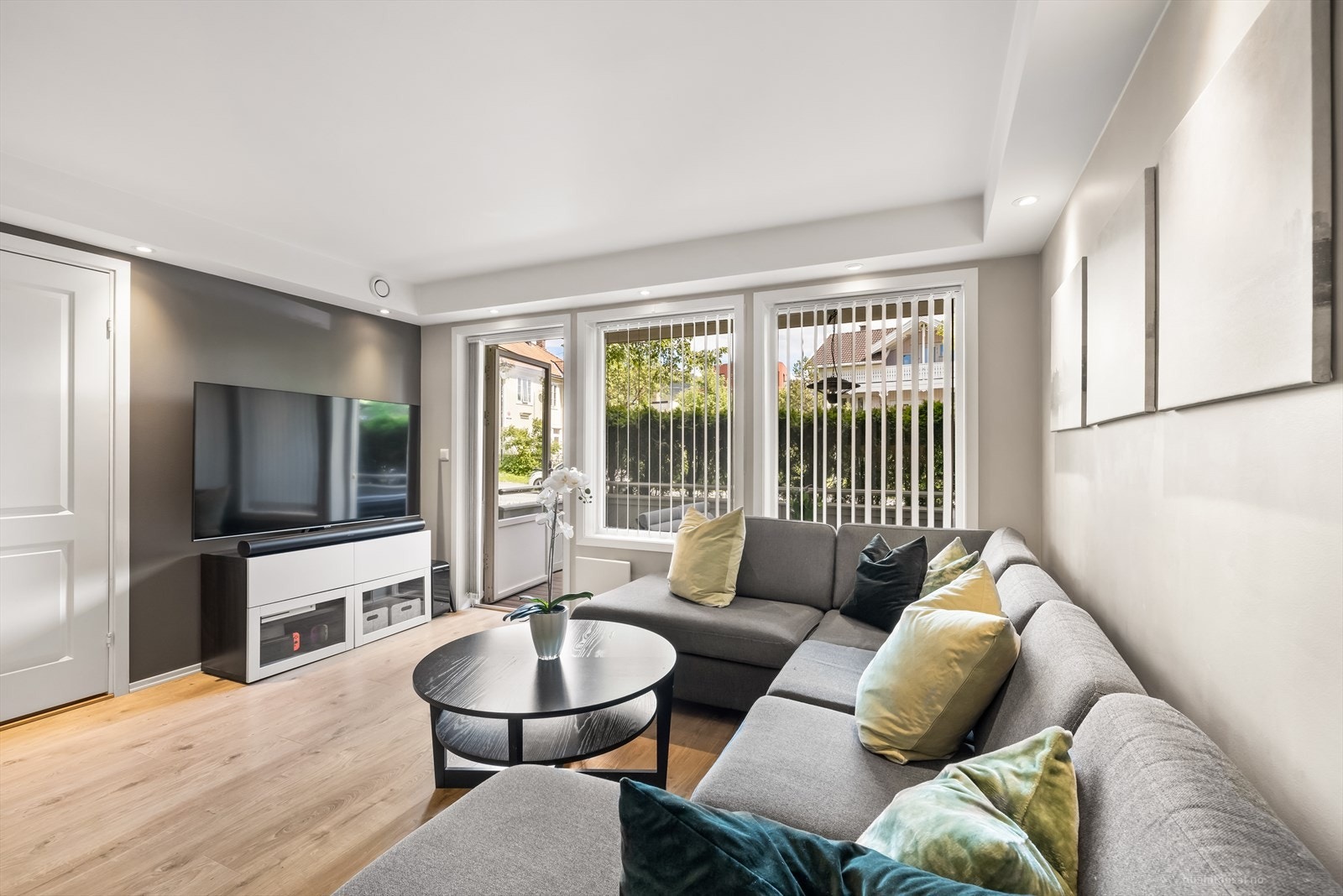 Stuen er malt i moderne farger og har utgang til balkong. Galleribilde