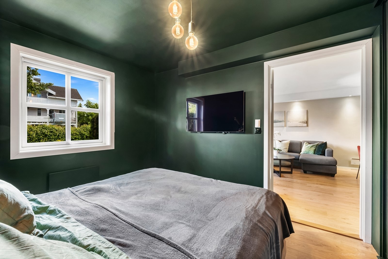 Leilighetens soverom er malt i en dyp grønnfarge og har plass til dobbeltseng. Galleribilde