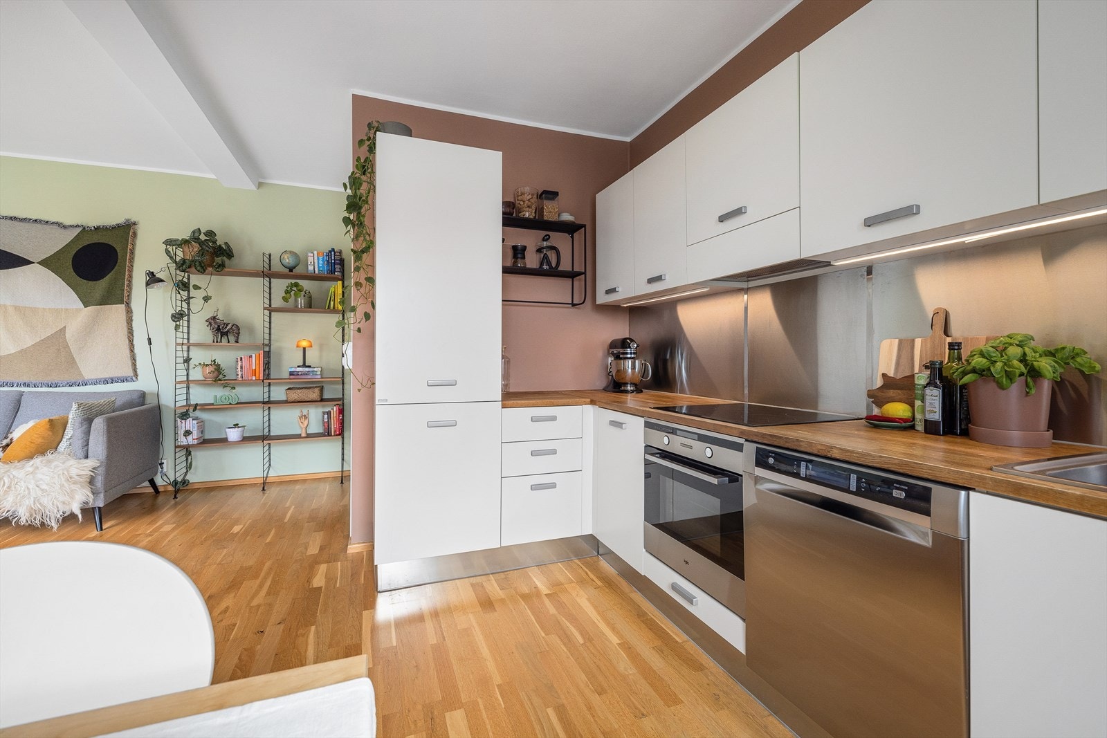 Pen innredning med glatte fronter og heltre benkeplate. Det er montert lys under overskap og stikkontakt Galleribilde