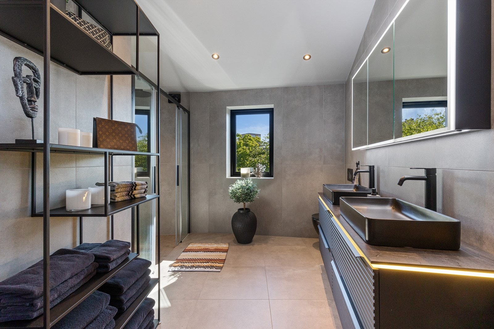 På badet er det to vaskeservanter, veggmontert wc og dusjnisje med glassdører. Galleribilde