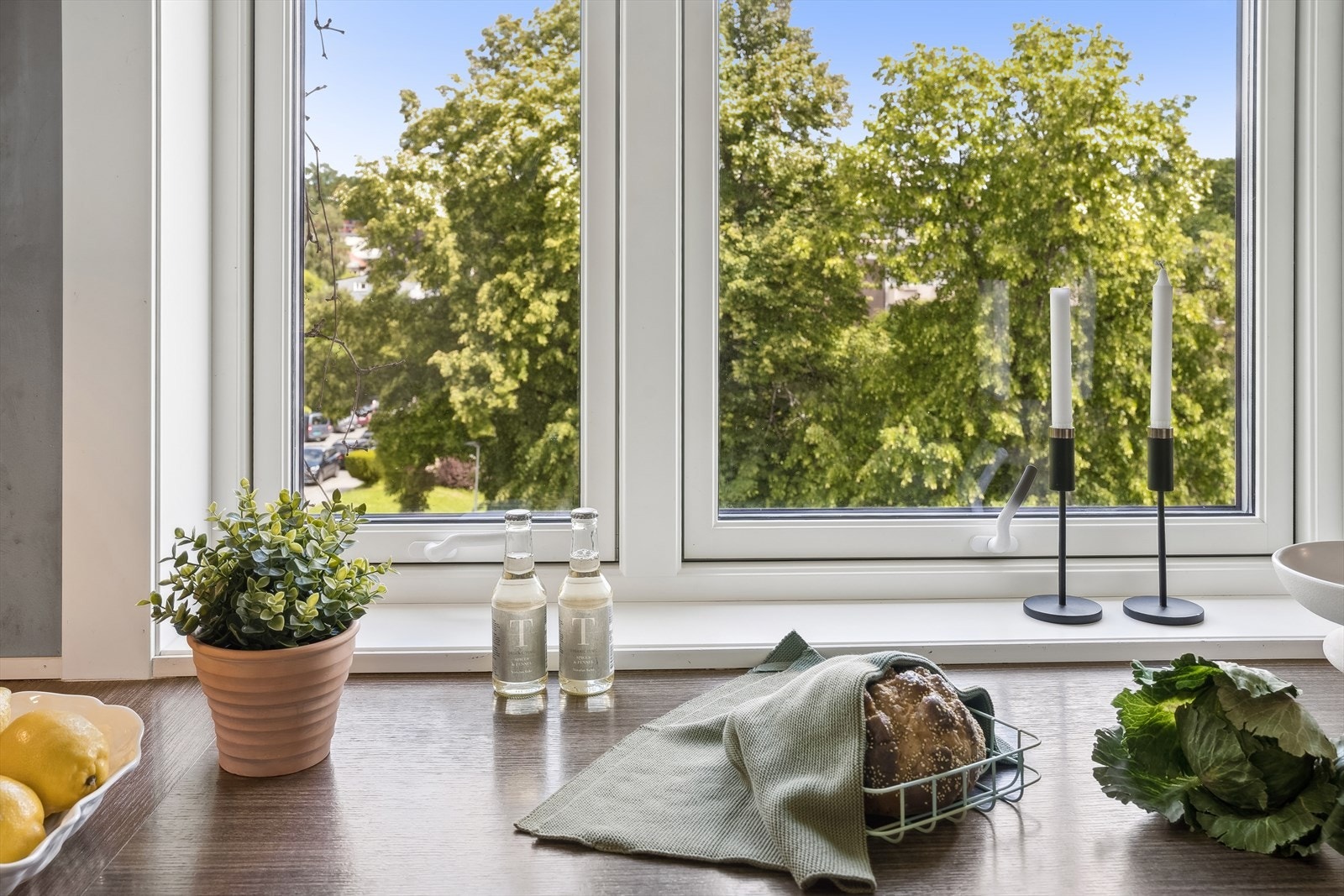 Kjøkkenet oppleves som moderne og sømløst med integrerte hvitevarer, og her kan hyggelig utsikt nytes mens matlagingen pågår Galleribilde