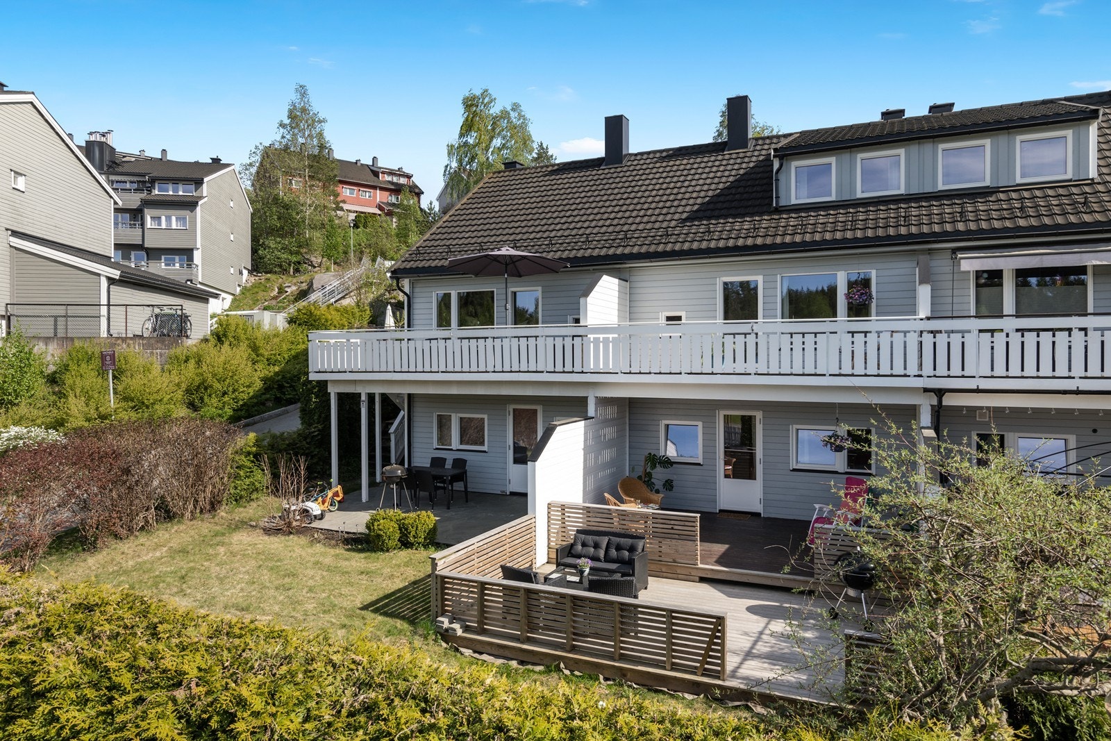 Pen bakhage opparbeidet med terrasse og plen, godt skjermet med levegg i trevirke. Galleribilde