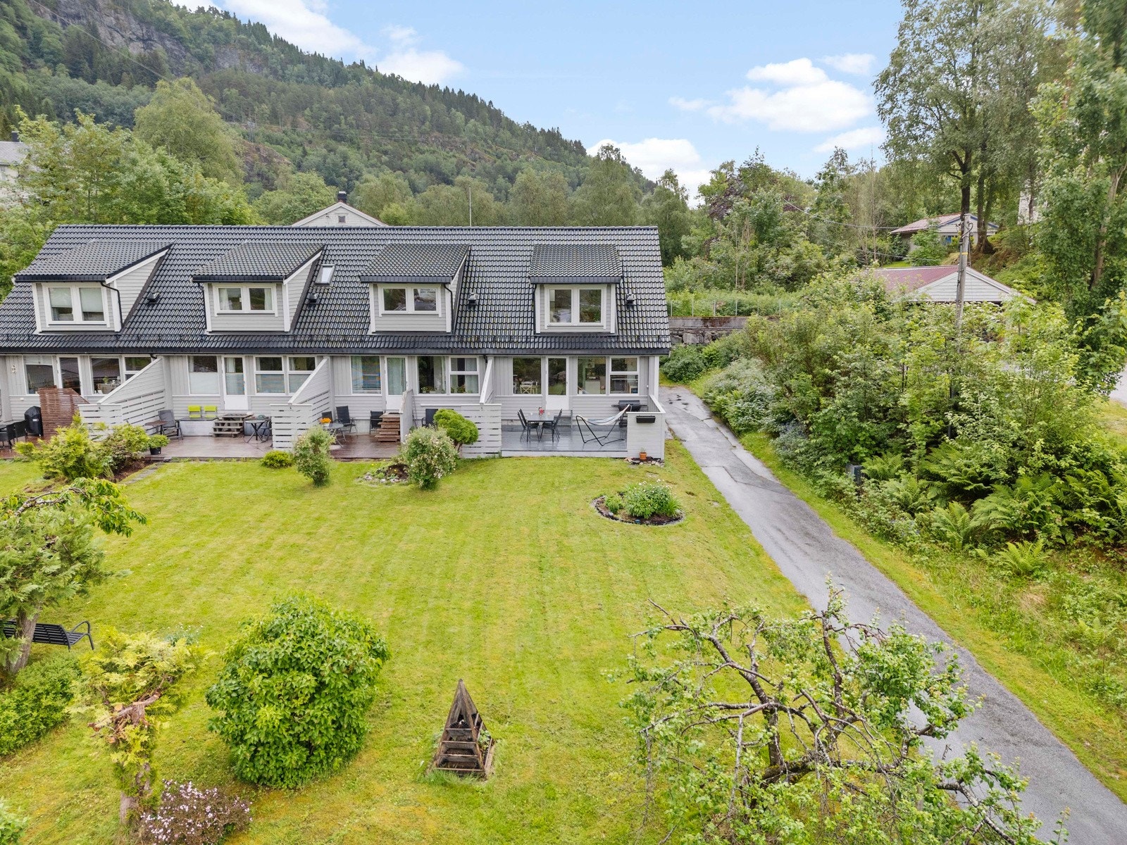 Framfor boligene er det fint opparbeida felles hage Galleribilde