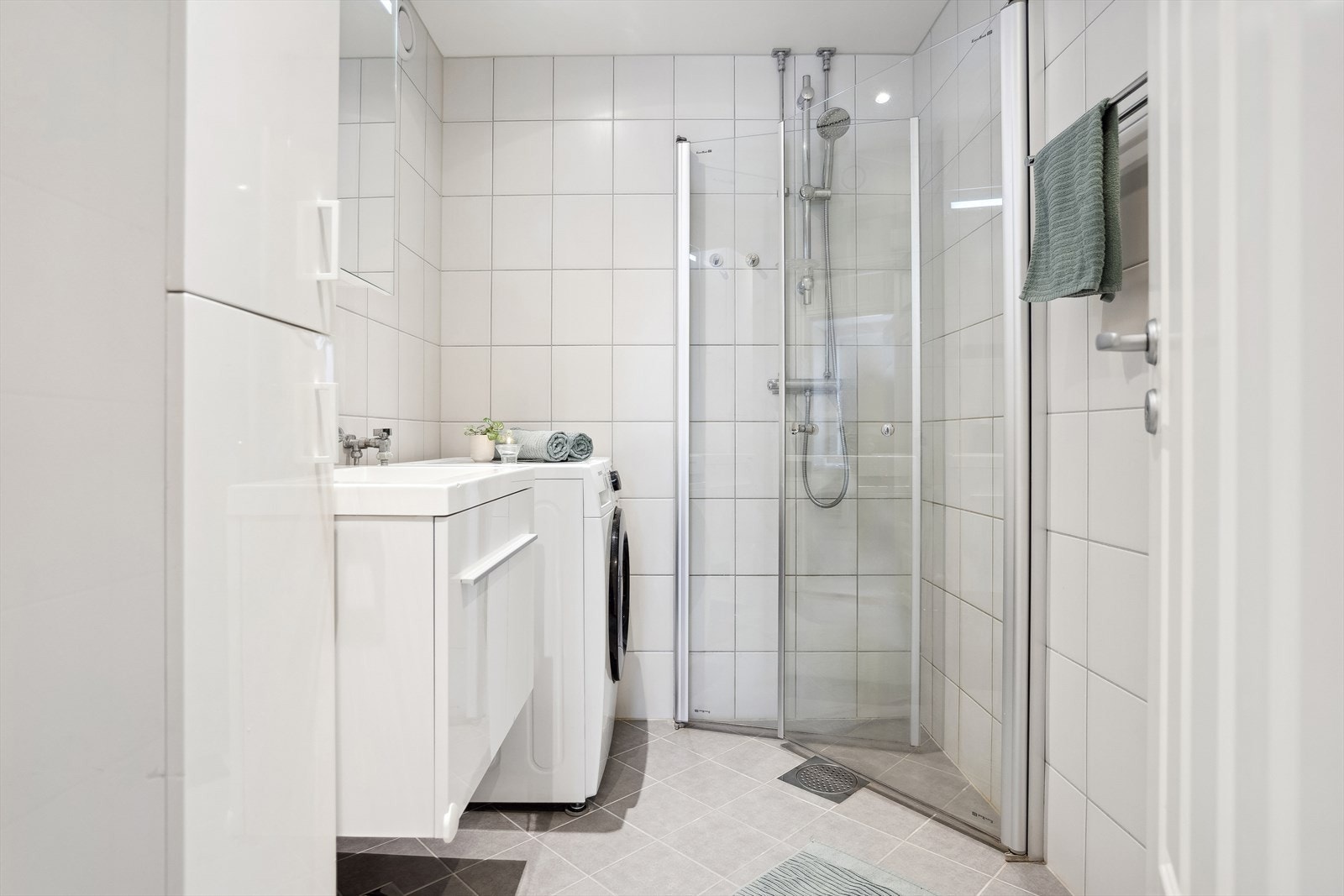 Tidløst flislagt bad med underliggende elektriske varmekabler samt malt innvendig himling med downlights Galleribilde