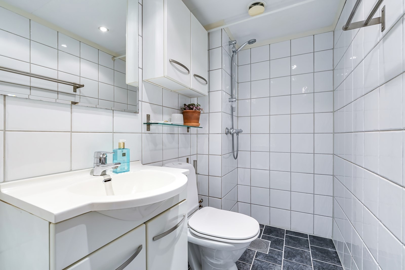Flislagt bad med gulvvarme og downlights i taket. Galleribilde