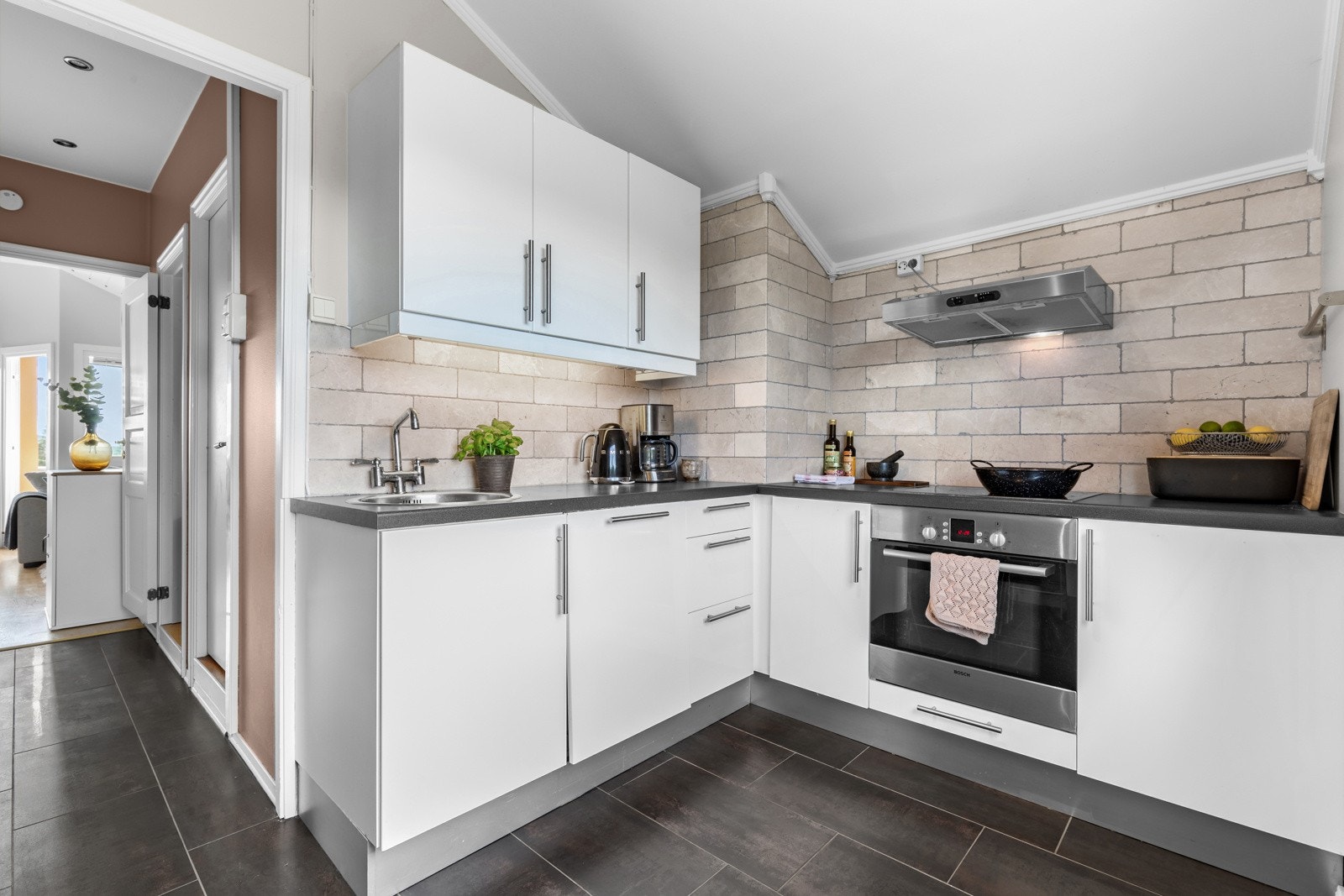 Boligen har et tidløst kjøkken som byr på godt med benkeplass. Kjøkkenventilator med kullfilter over stekesonen Galleribilde