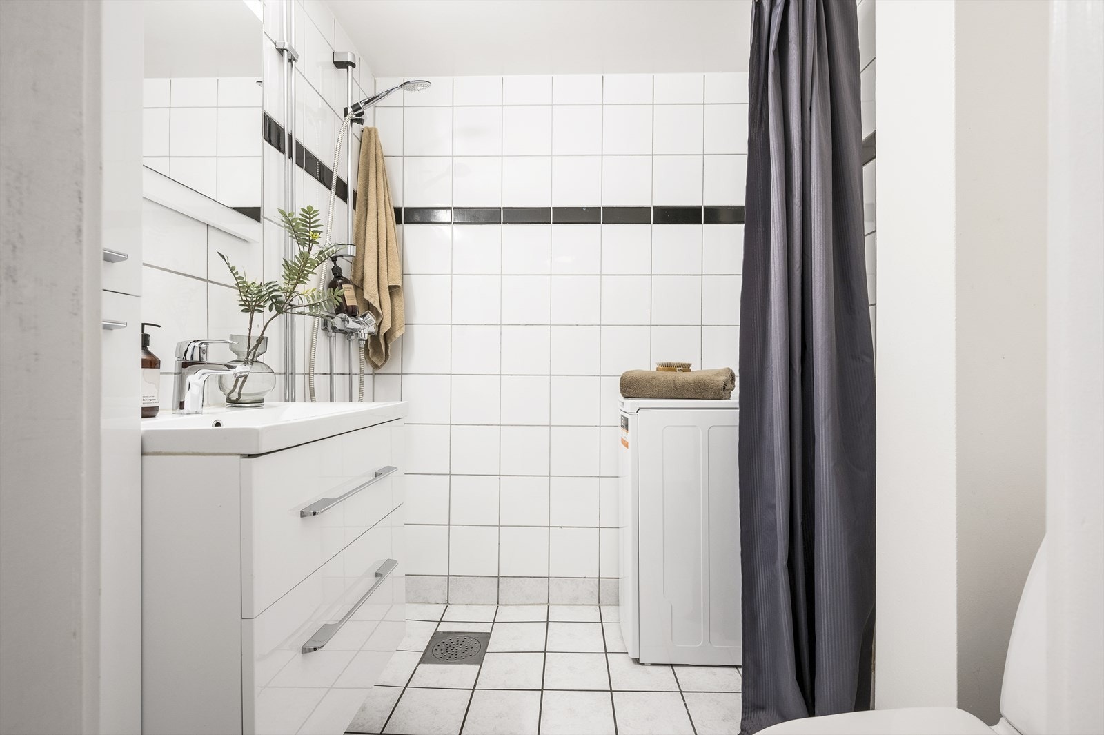Flislagtbad med varmekabler på gulv samt opplegg for vaskemaskin. Galleribilde