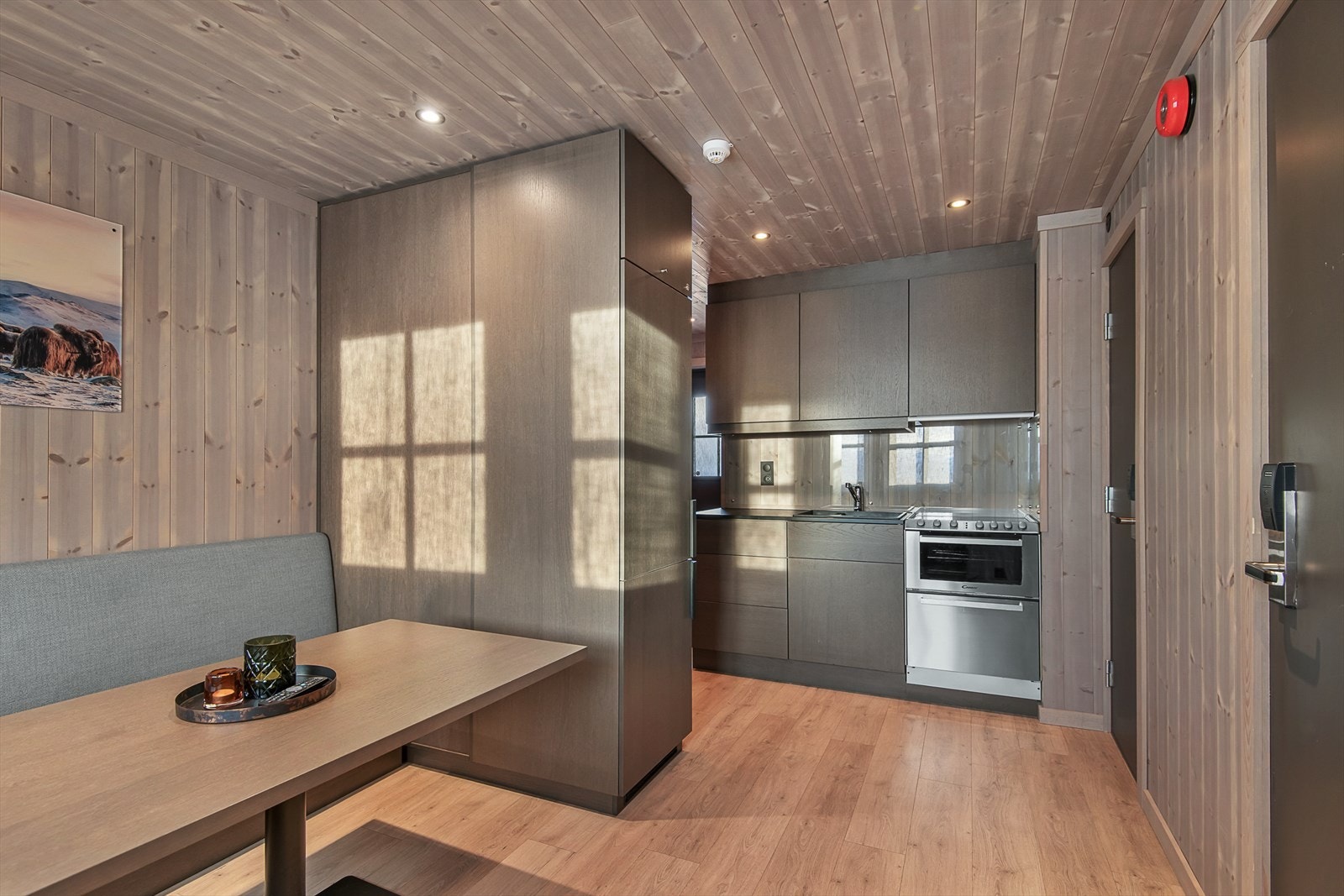 Stuen er lun og trivelig. Det er en praktisk plassbygd sofagruppe med tilhørende bord. Galleribilde