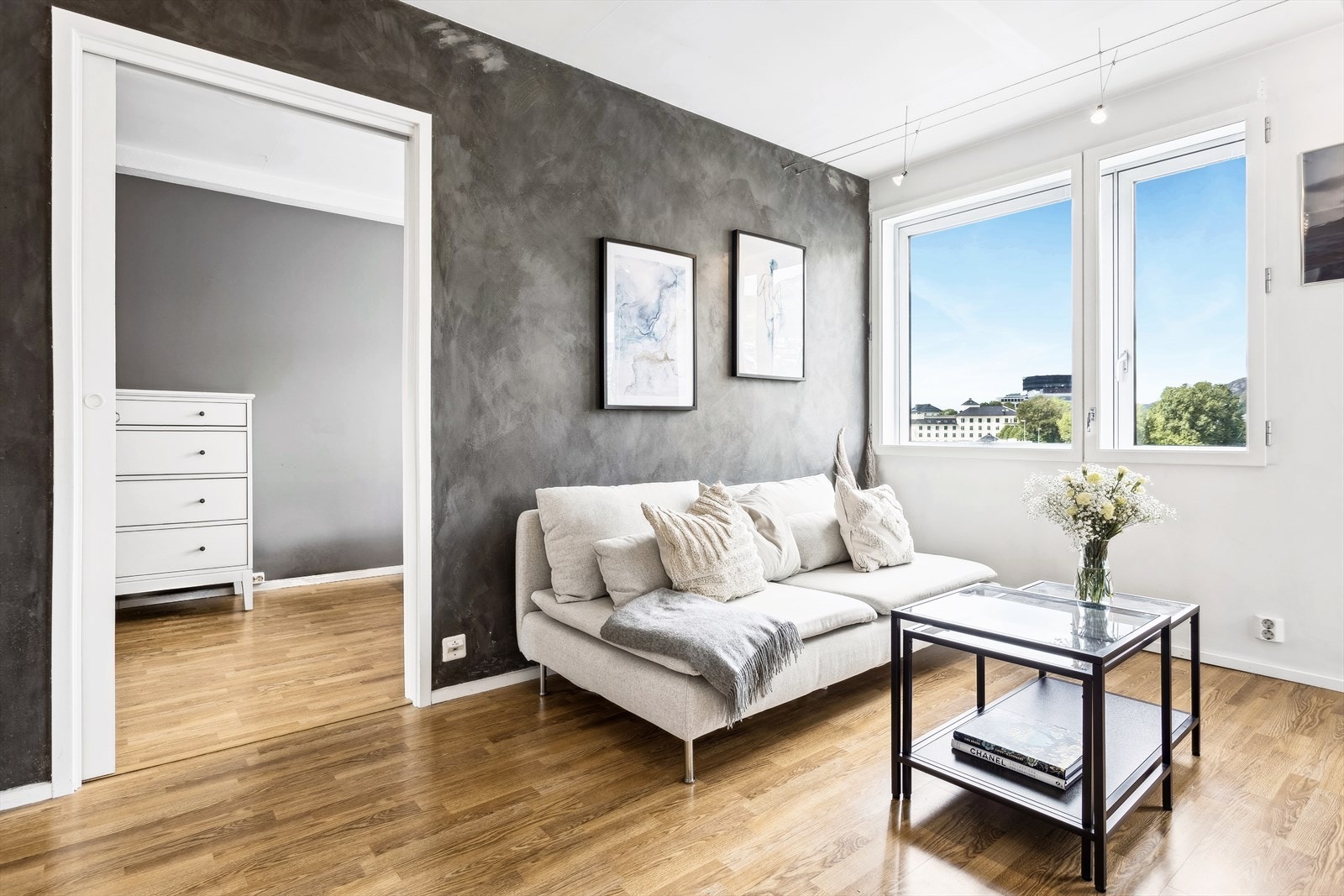 Stuen har tøff gråmalt fondvegg. Laminatparkett på gulv. Galleribilde