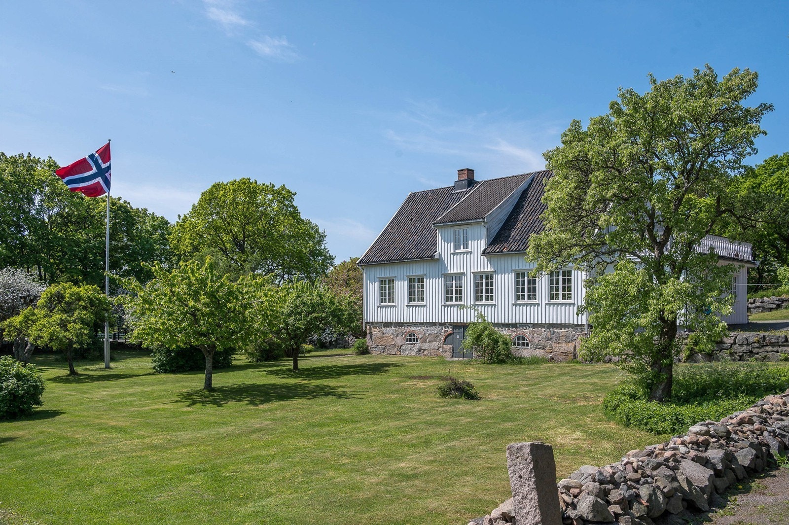 Stor hage med frukttrær, busker og plen. Galleribilde