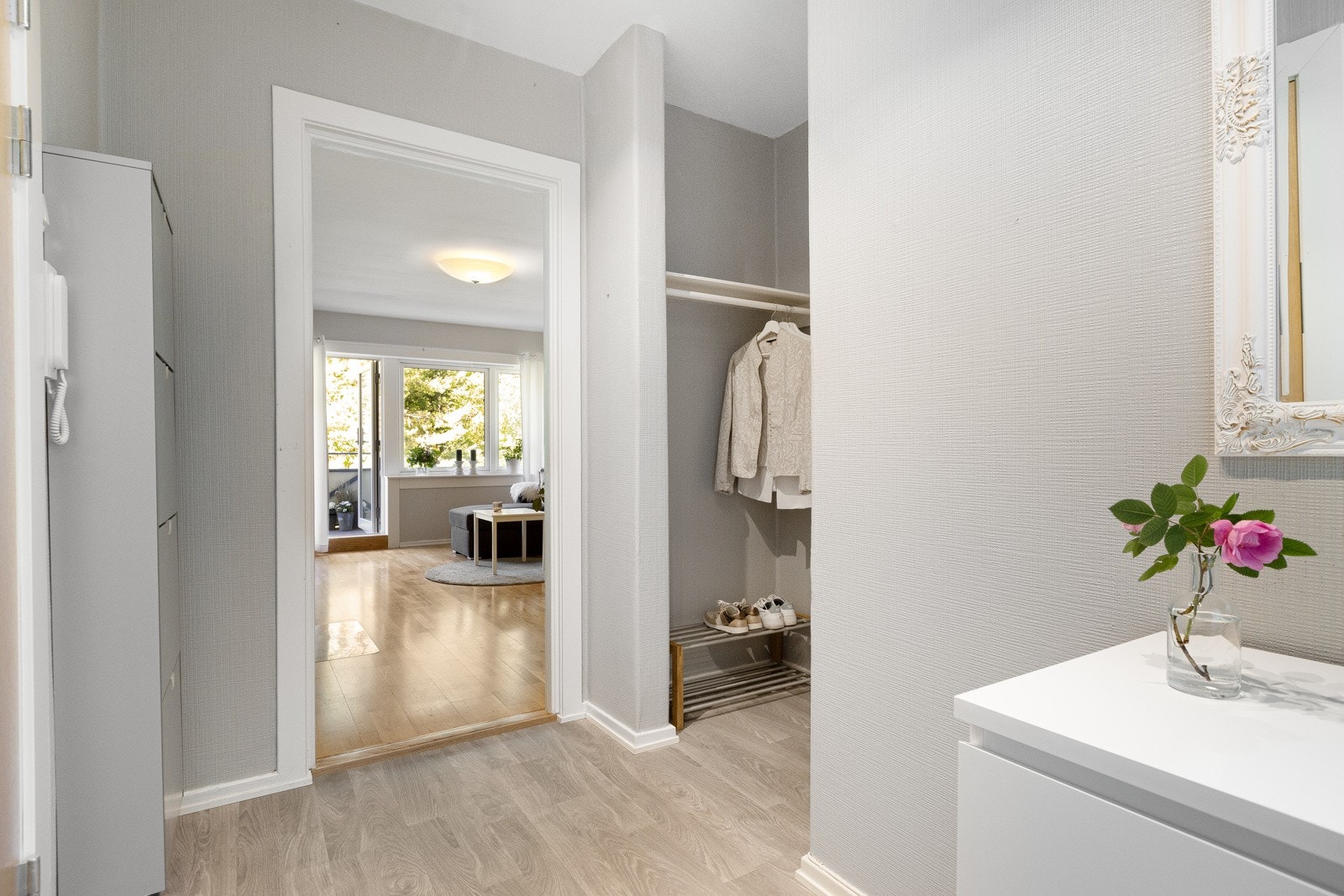 Lys og innbydende entré med laminat på gulv og god plass til møblement for oppbevaring av sko og yttertøy. Galleribilde