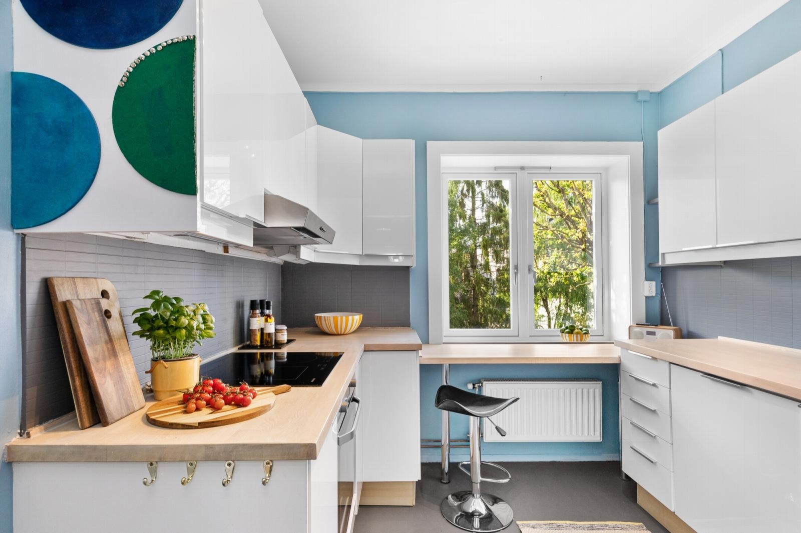 Pent separat kjøkken med frokostplass og hyggelig utsikt mot bakgård. Galleribilde