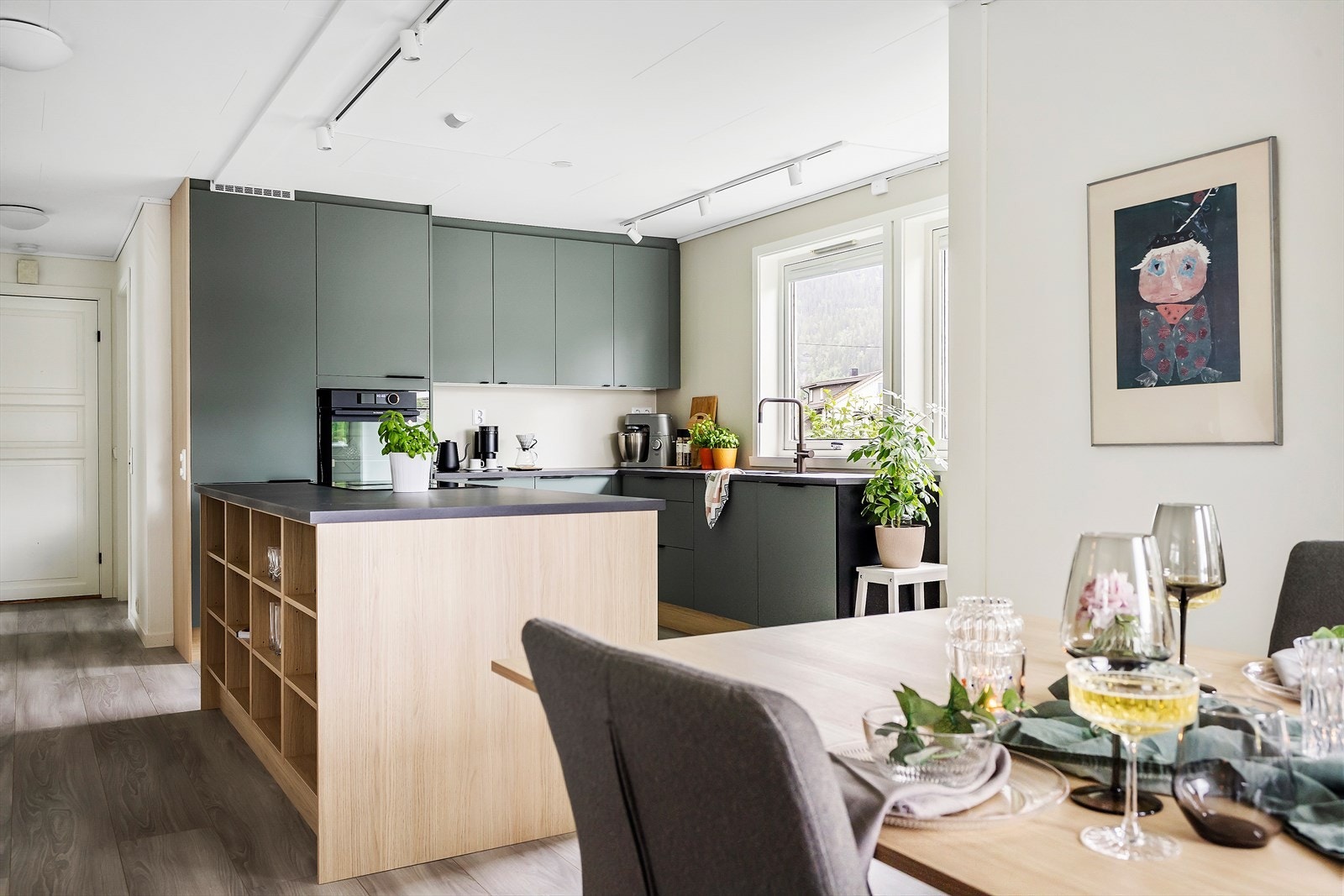 Innredningen er lekker, med en miks av fronter i matt skogsgrønn farge, håndtak i sort og skrog i eikefarget materiale. Her har du meget god plass til kopper og kar, så vel som gode arbeidssoner. Galleribilde